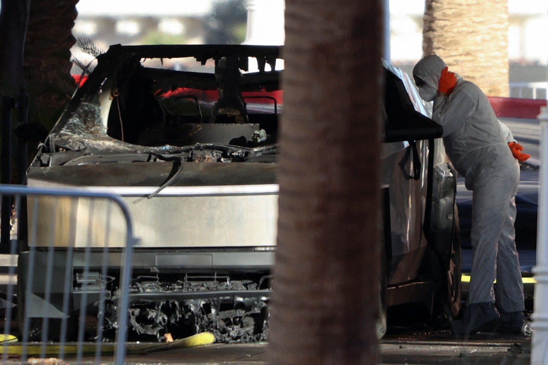 Firefighters work at the Tesla Cybertruck which burned at the entrance of Trump Tower in Las Vegas