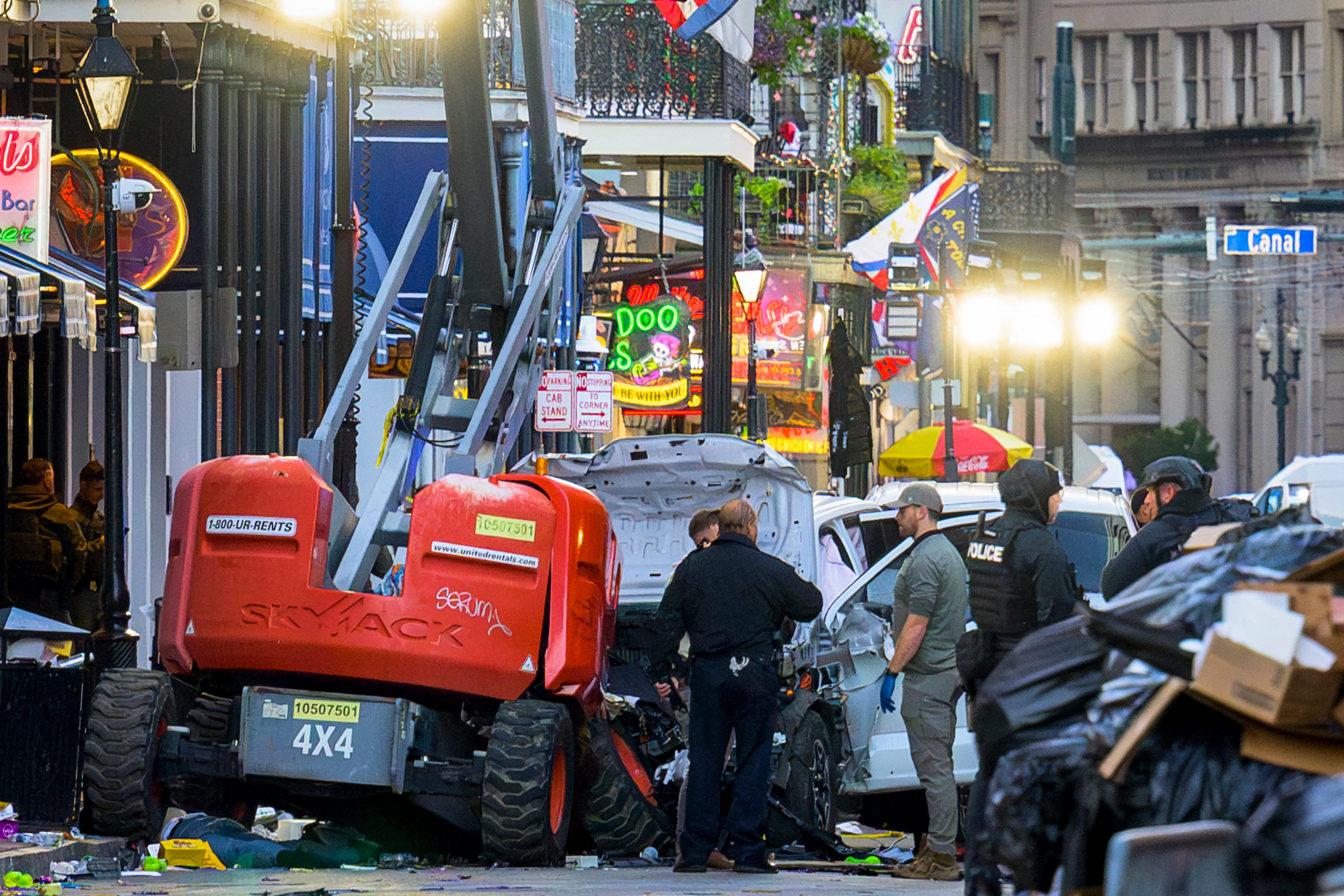 Police investigators surround a white truck that has been crashed into a work lift in the French Quarter of New Orleans, Louisiana, on January 1, 2025.