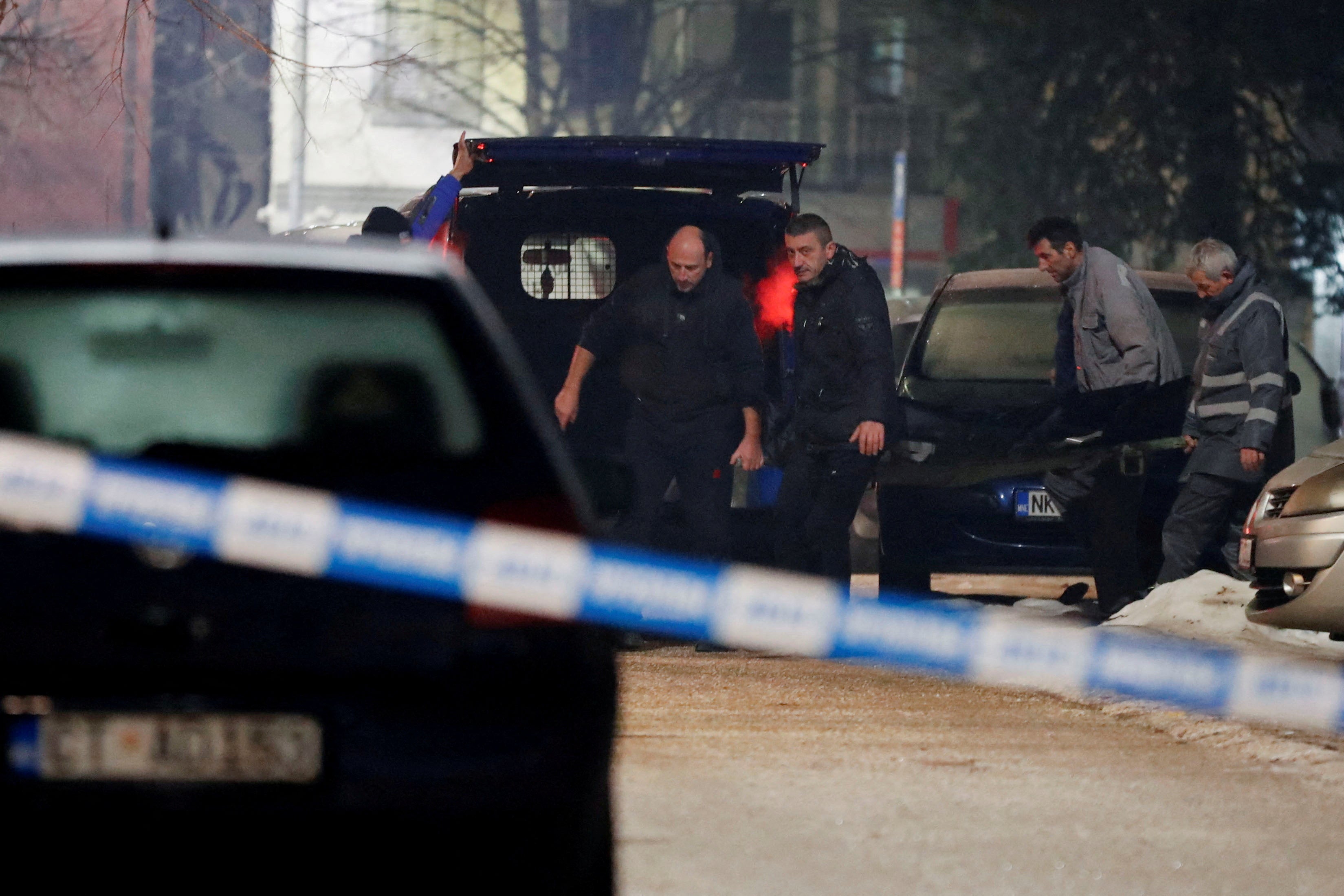 Workers at the scene after a gunman opened fire and killed several people in a restaurant in Cetinje, Montenegro