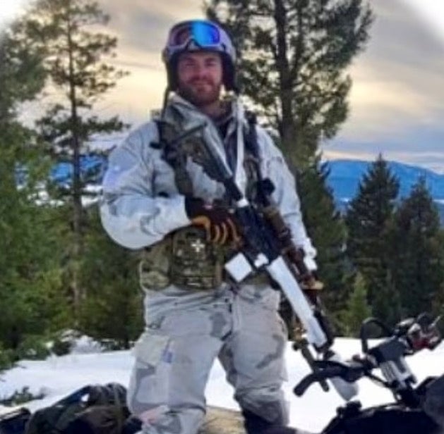 The profile picture on Livelsberger’s LinkedIn account shows a man sporting winter gear armed with a rifle, standing atop of a snowmobile in mountainous terrain