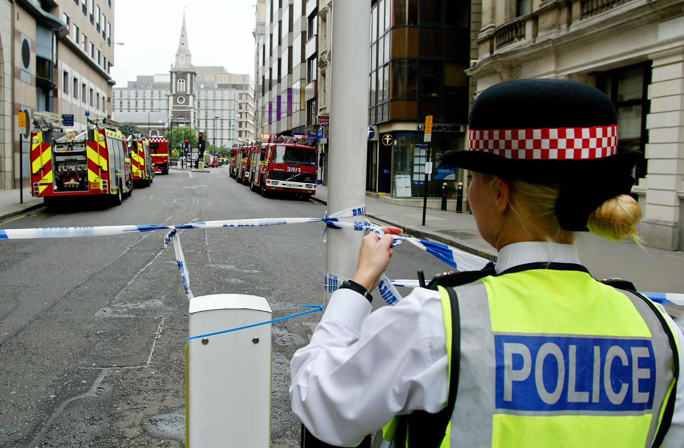 A police officer blocks access to Aldgate East station