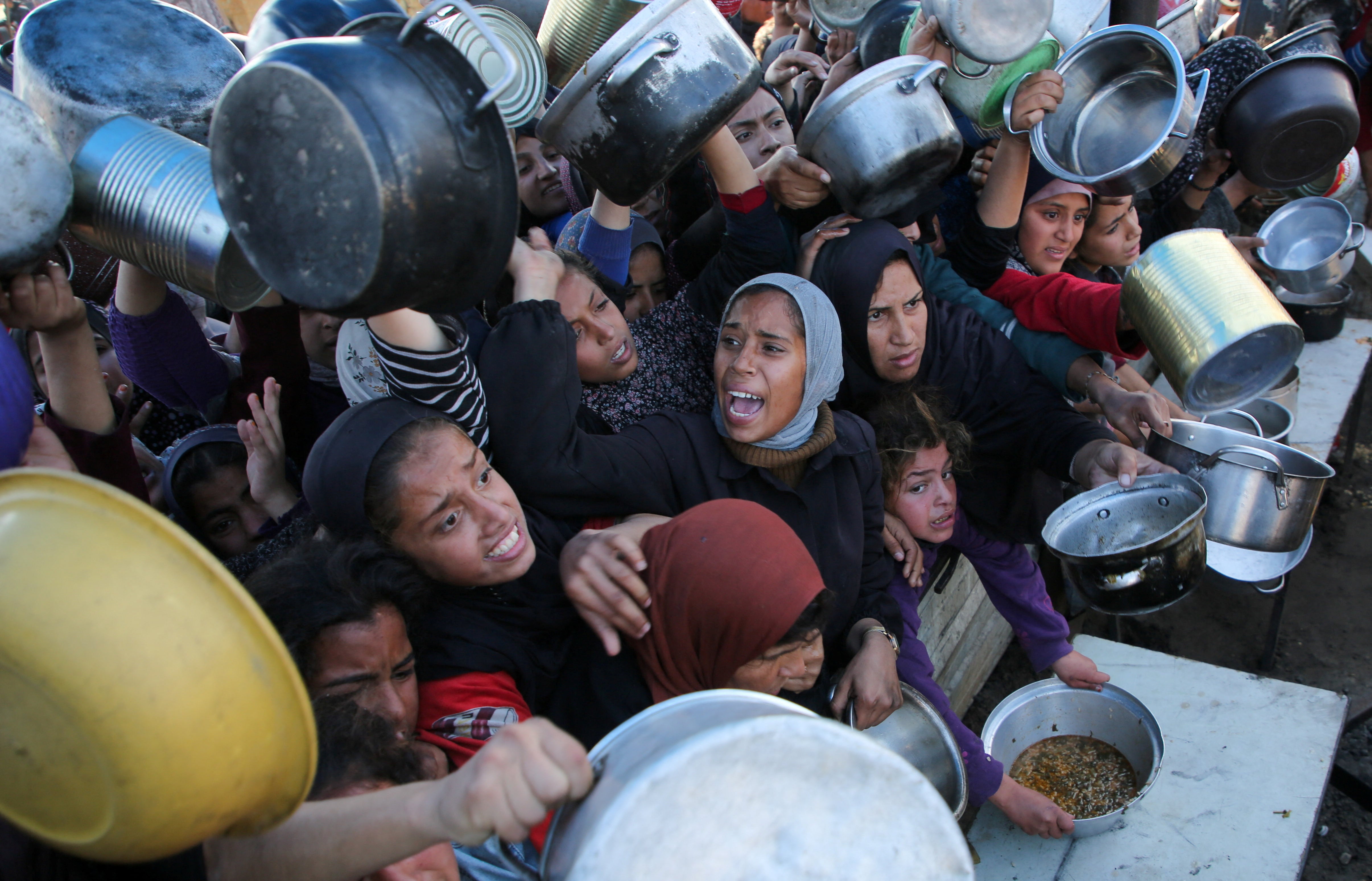 Palestinian refugees at a charity kitchen in Khan Younis