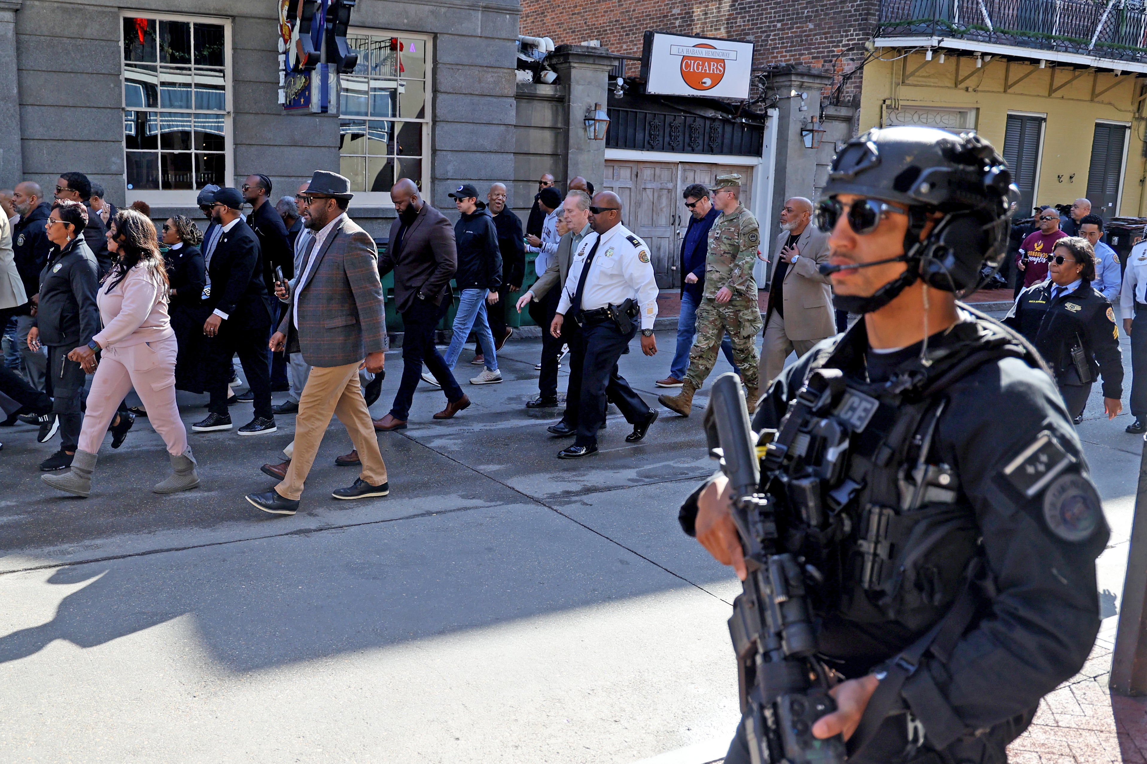 Law enforcement guards the entrance to Bourbon Street as city officials re-open the street less than two days after a massacre