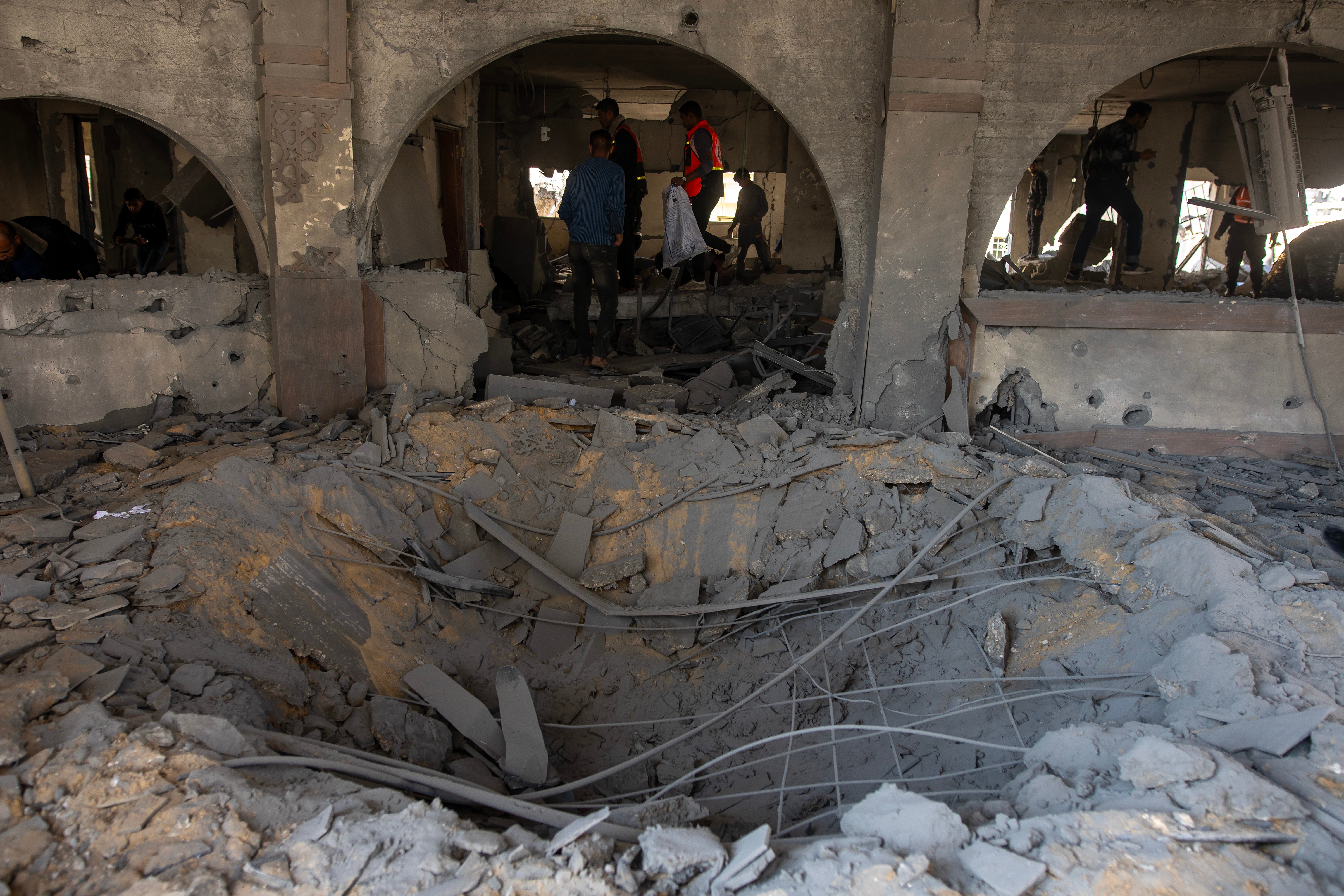 Palestinians inspect the site of an Israeli airstrike in Khan Yunis in southern Gaza on 2 January 2025