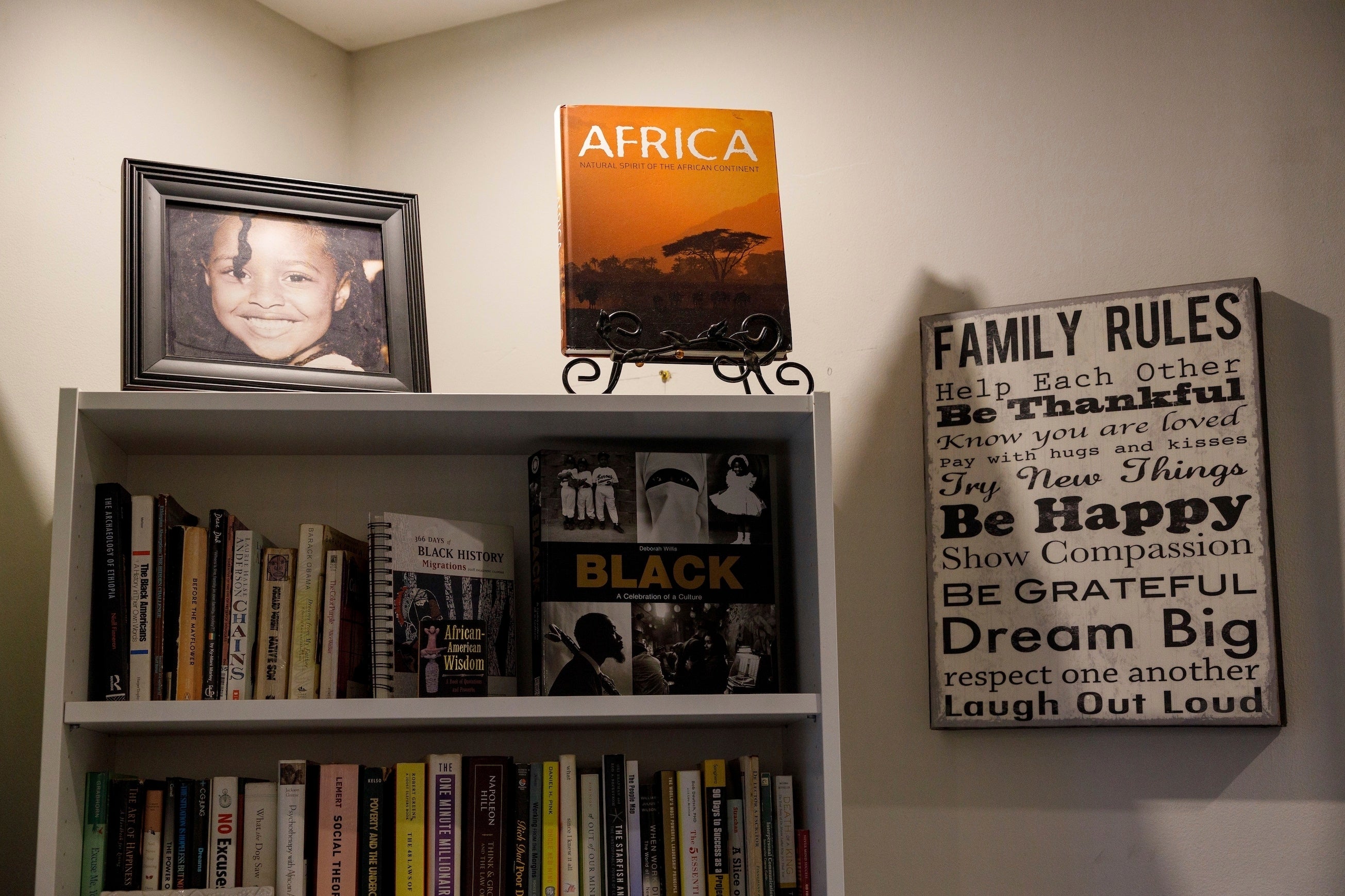 African books sit on the bookshelf at the Keachia Bowers and Damon Smith’s family home in Accra, Ghana