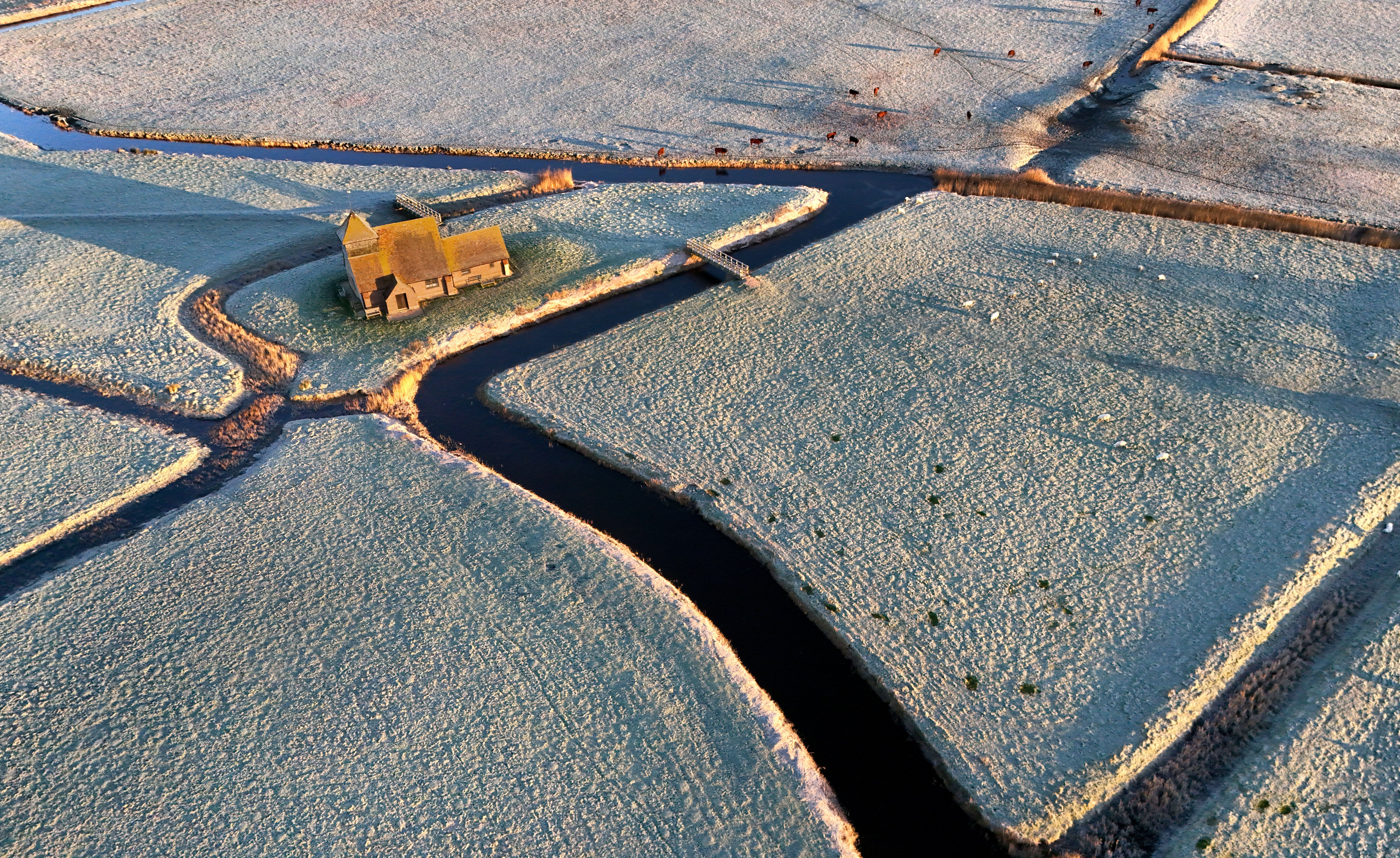 St Thomas Becket church is surrounded by frosty fields on the Romney Marsh in Kent