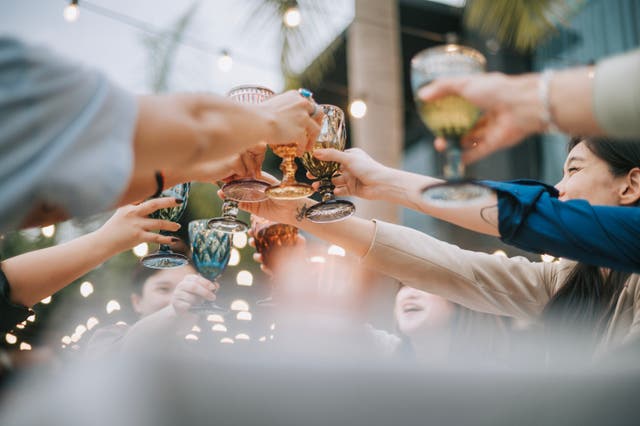 <p>People toast with glasses of  alcohol. A new report from the U.S Surgeon General says alcohol should come with updated health labels warning about links to cancer </p>