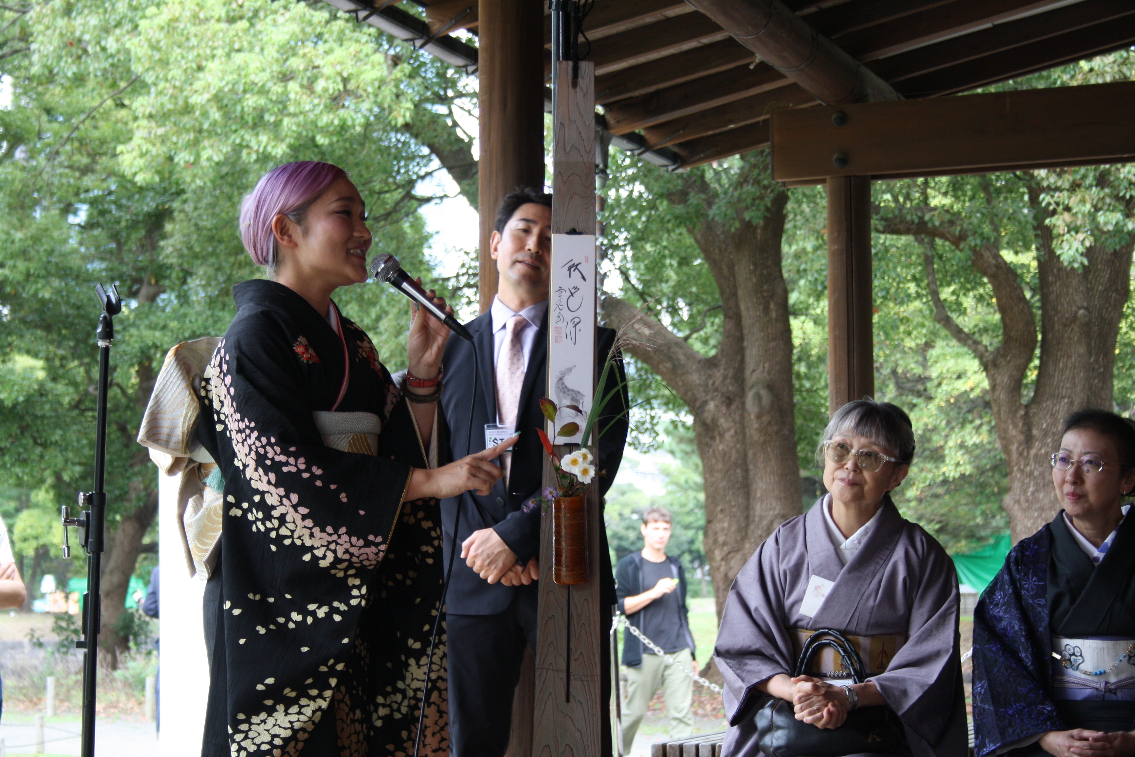 Alpha Takahashi (left) provides translation at the Grand Tea Ceremony in Tokyo