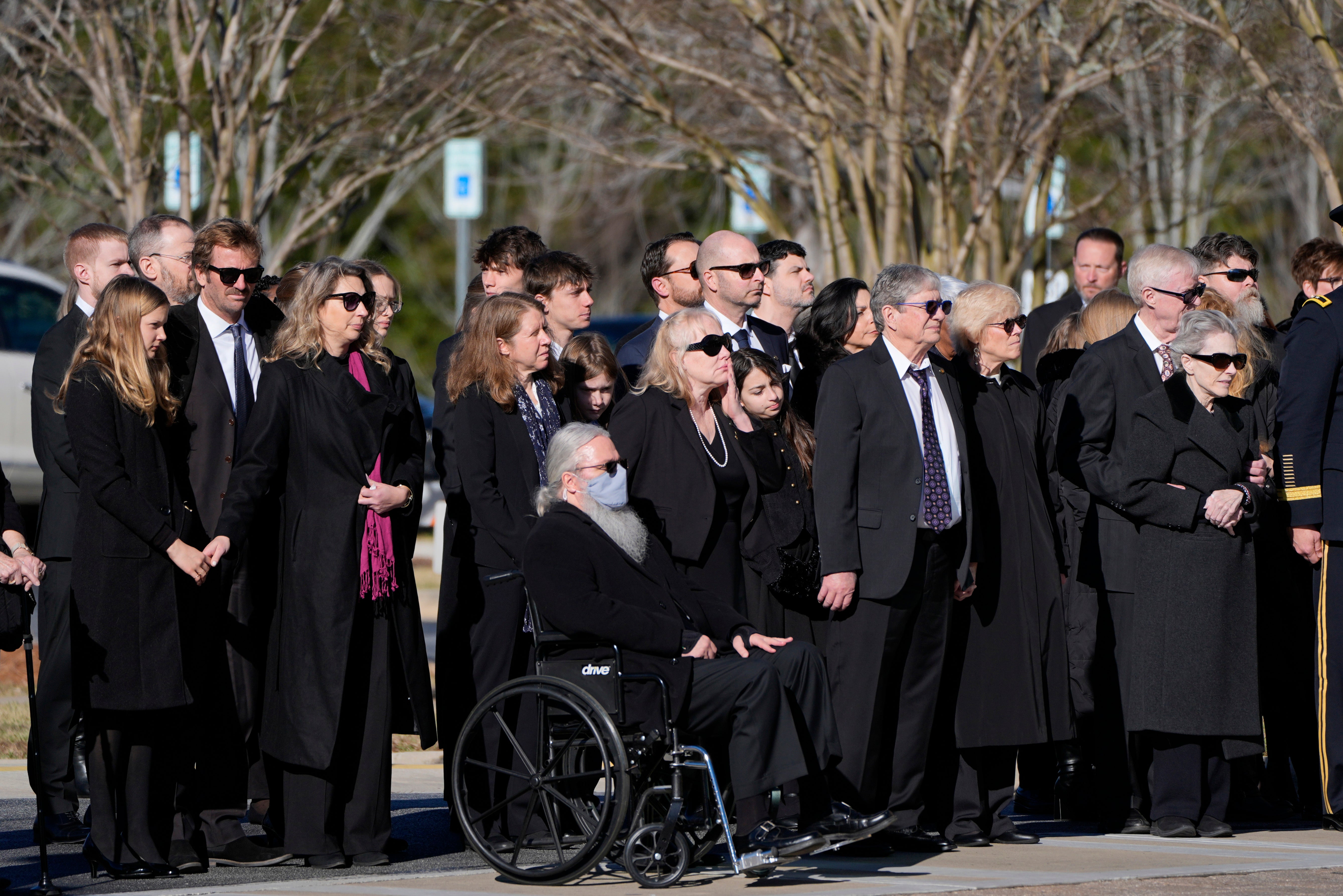 Carter’s family watches as former and current Secret Service agents assigned to his detail carry his casket into a hearse