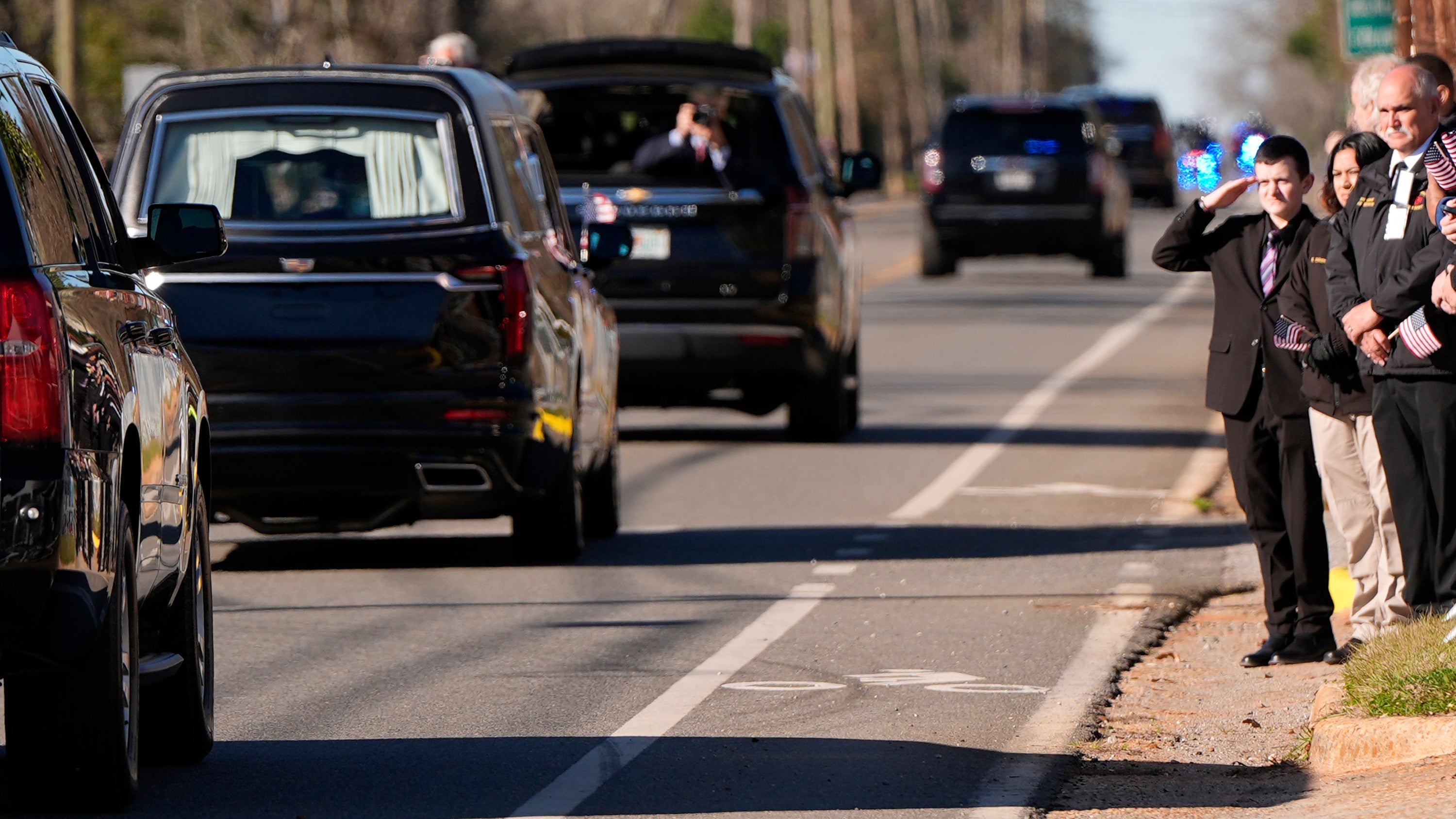 A mourner salutes Carter’s hearse as it drives through Plains, Georgia