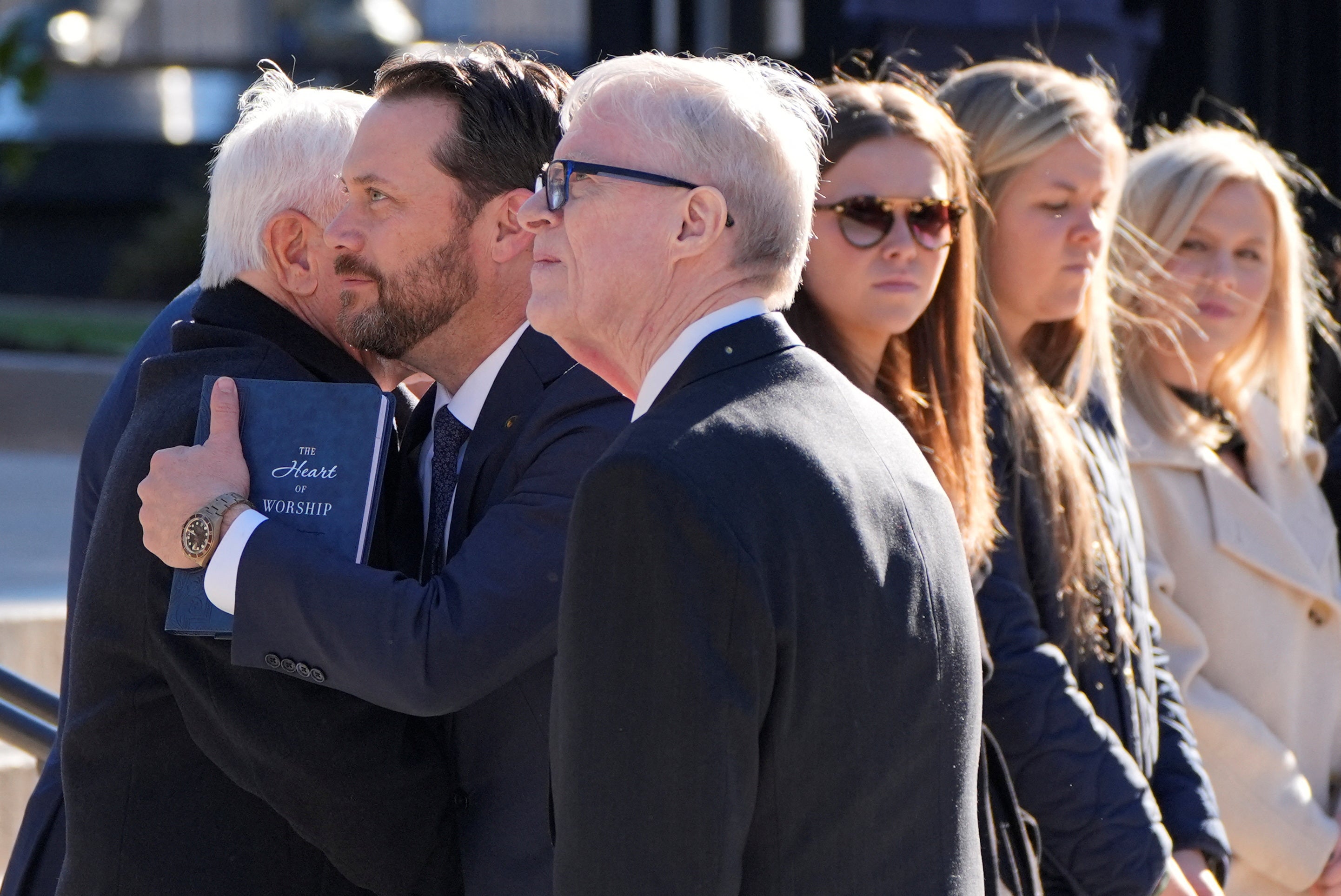 Jimmy Carter’s son, Jack Carter, and grandson Jason Carter watch as his hearse arrives in Atlanta, Georgia