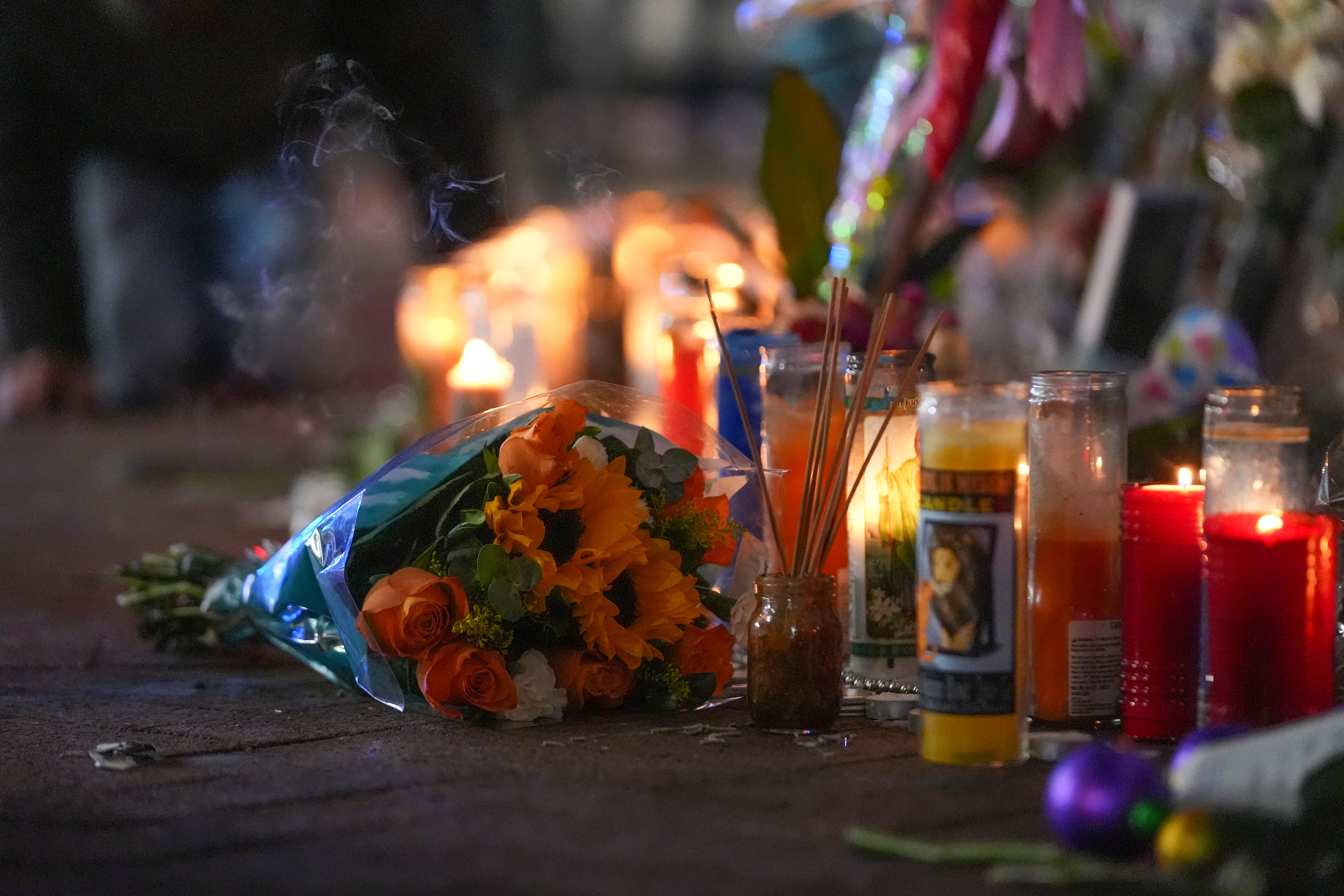 Flowers lie next to candles at a memorial for the victims of a deadly truck attack on New Year's Day