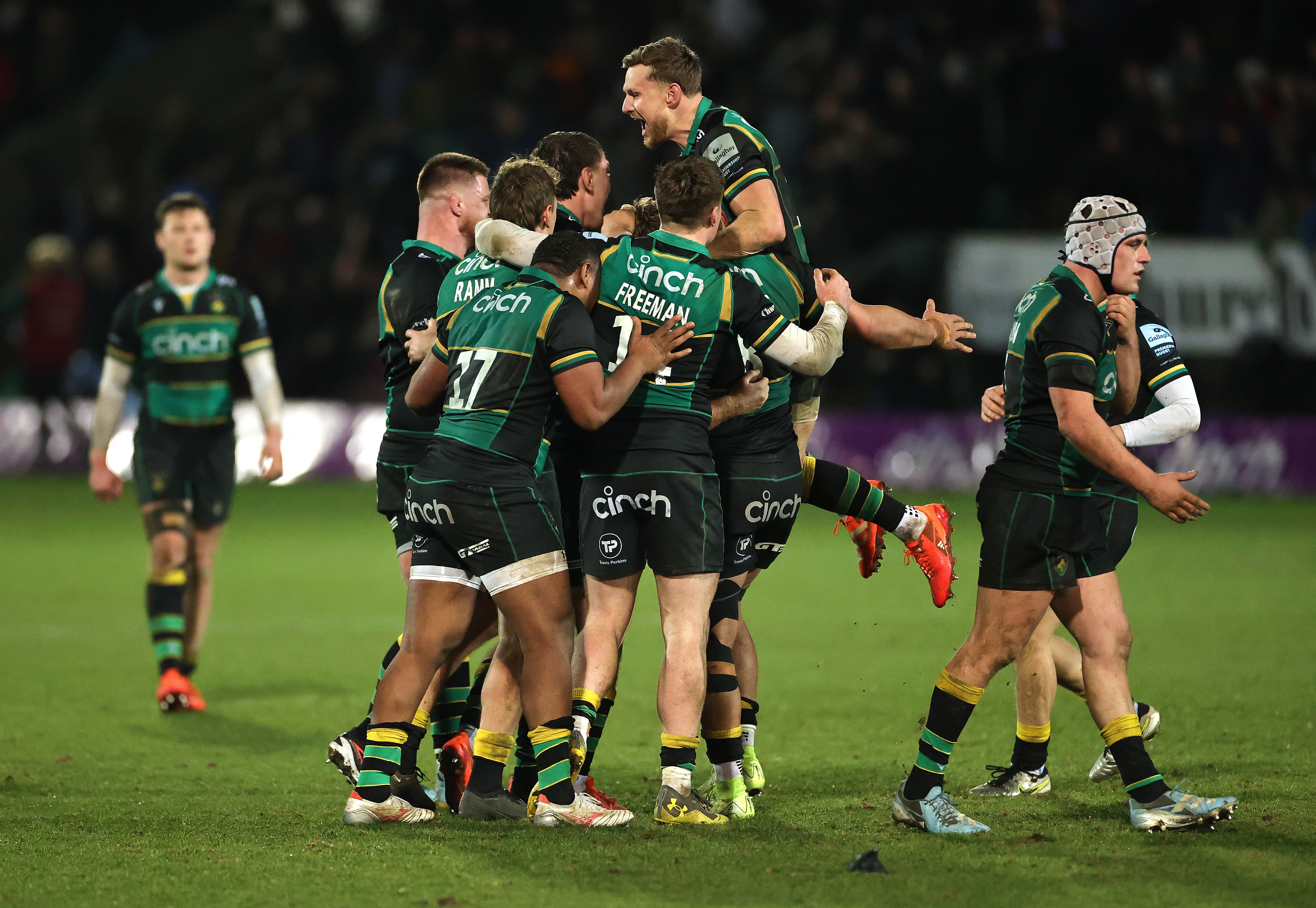 Northampton Saints players celebrate after Fin Smith kicks the match-winning penalty