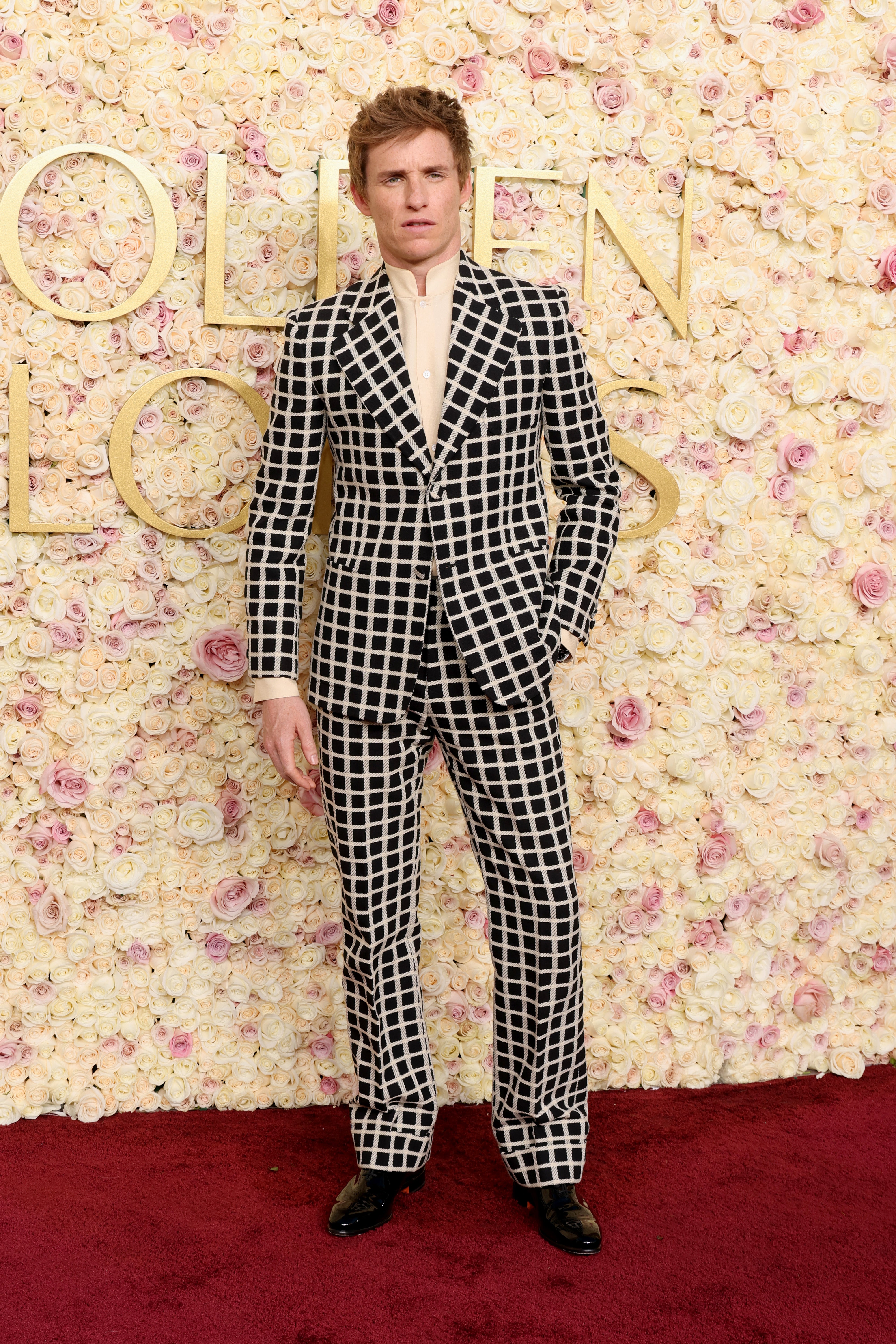 Eddie Redmayne wears a checkered suit to the Golden Globes