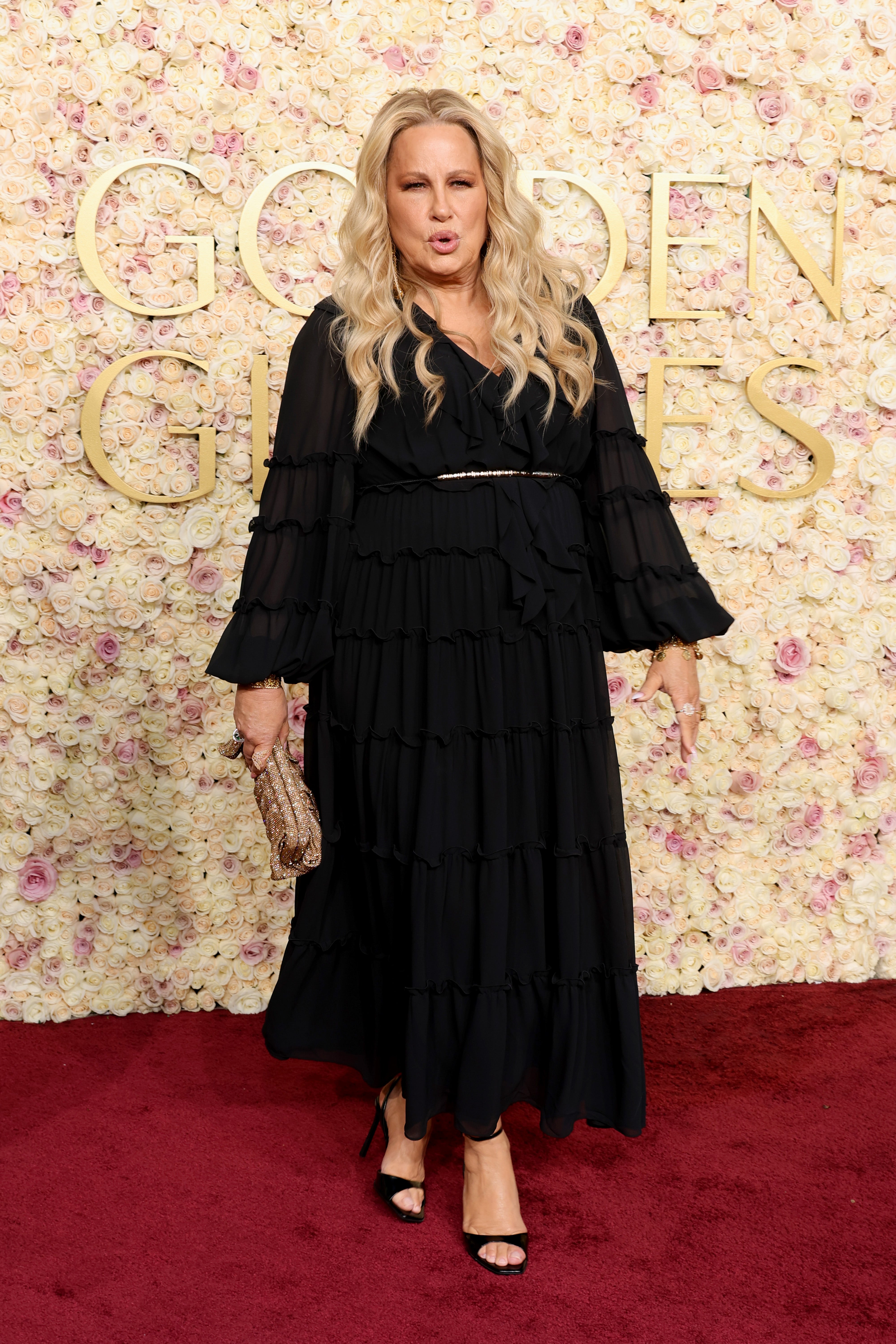 Jennifer Coolidge dons an all-black gown with a white belt at the Golden Globes