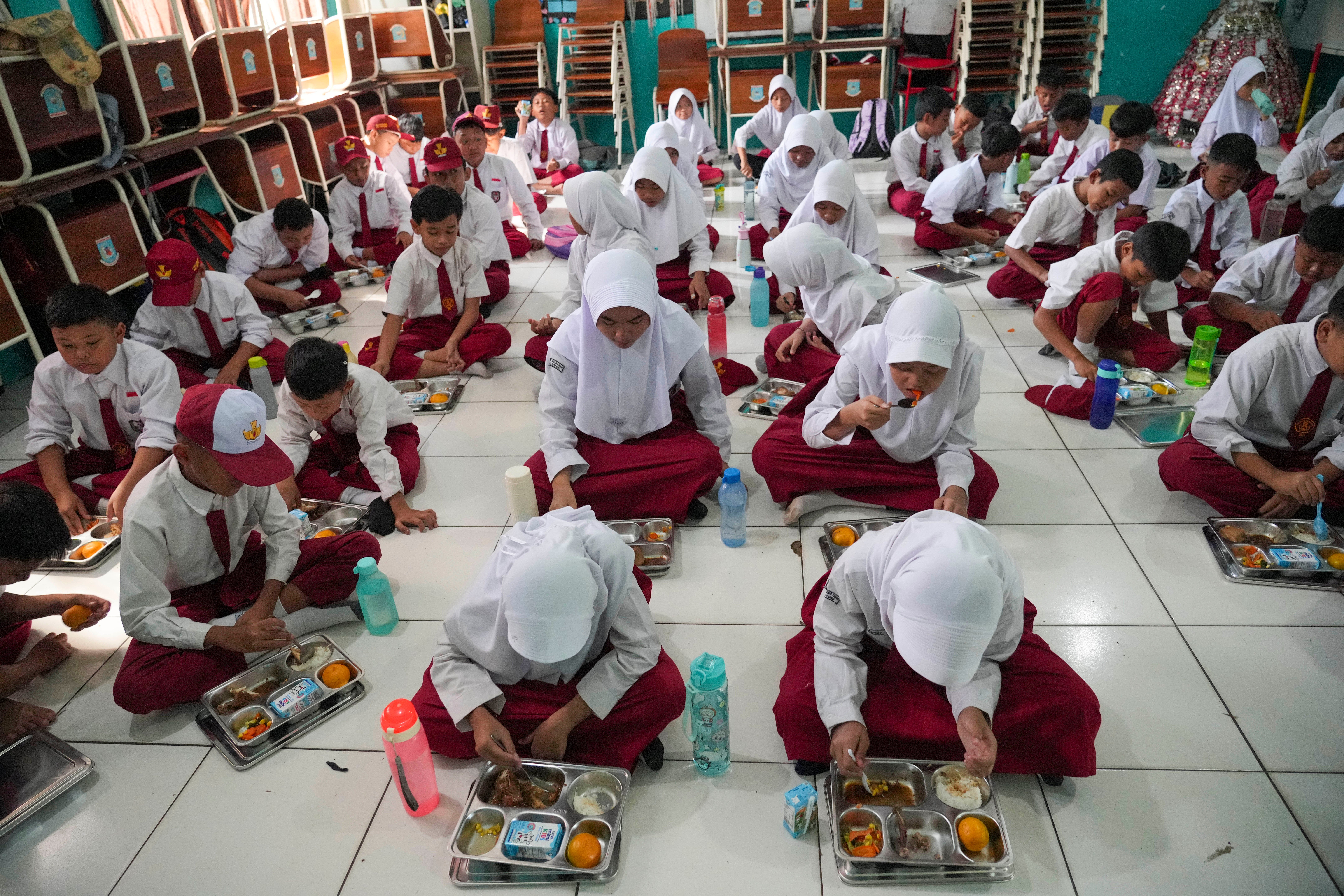 Students eat lunch at an elementary school in Banten, Indonesia