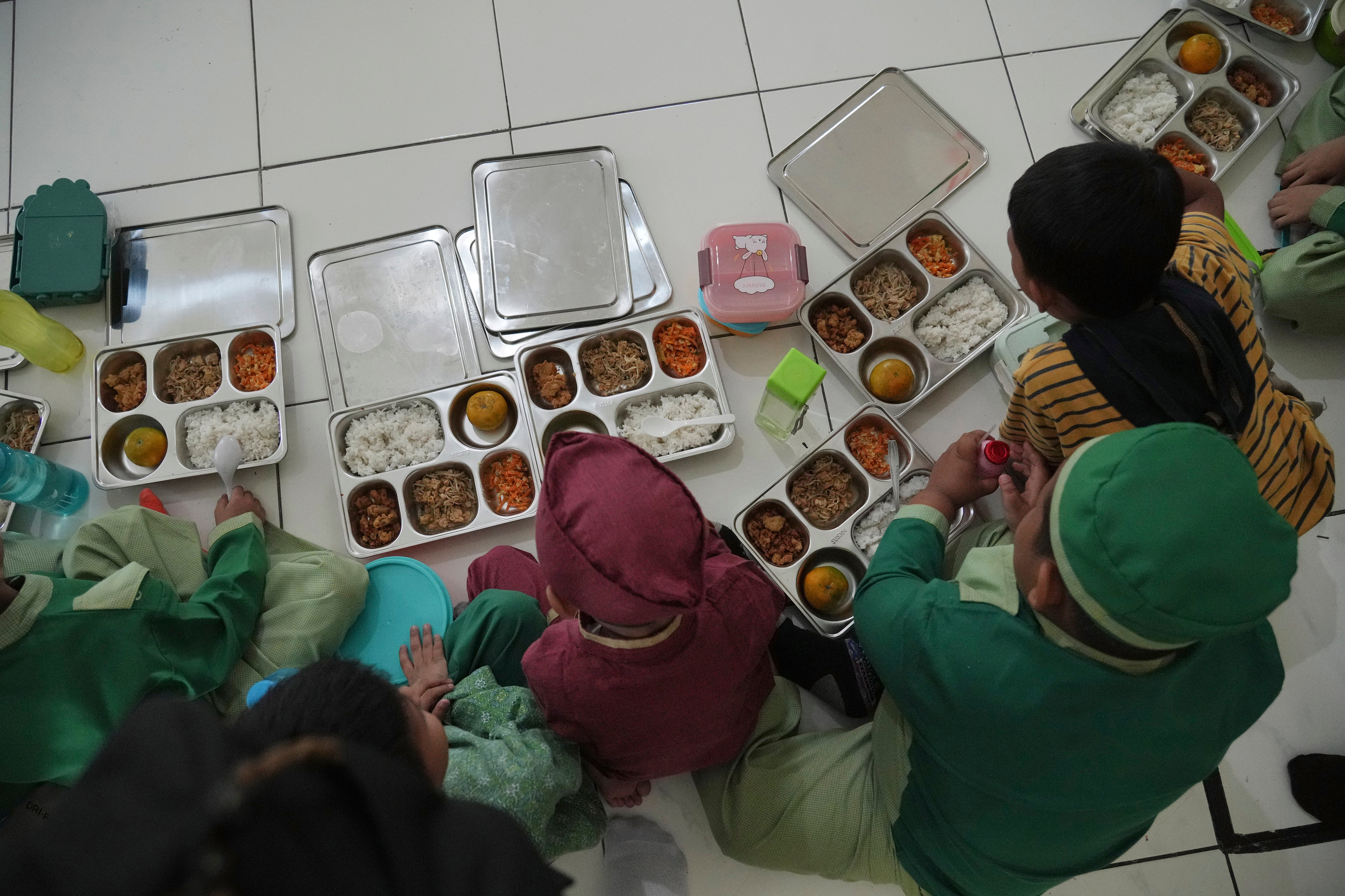 Students tuck into meals provided through President Prabowo Subianto's ambitious free meal programme