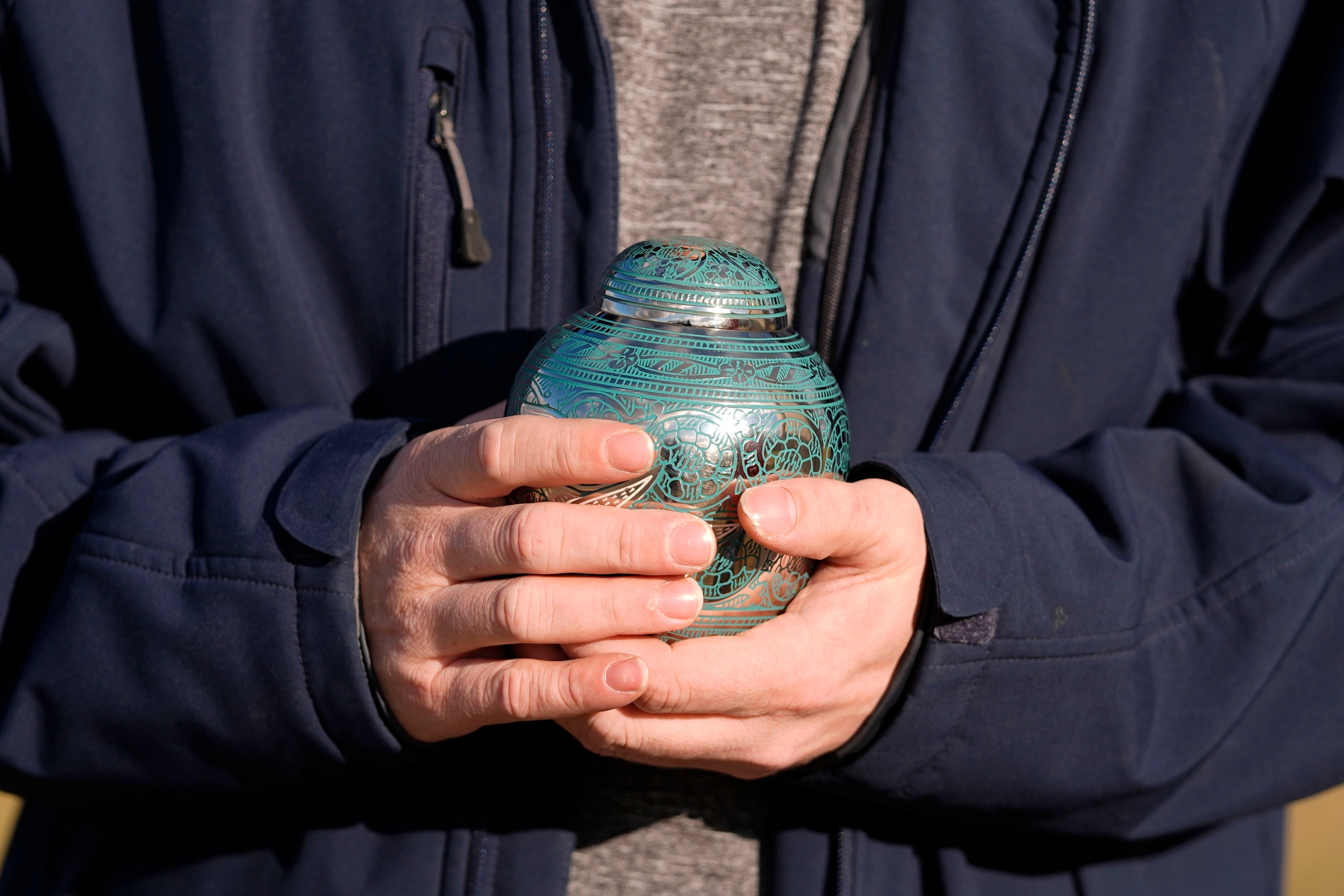 Eric Pranger holds an Urn that contains the ashes of Allen Livingston