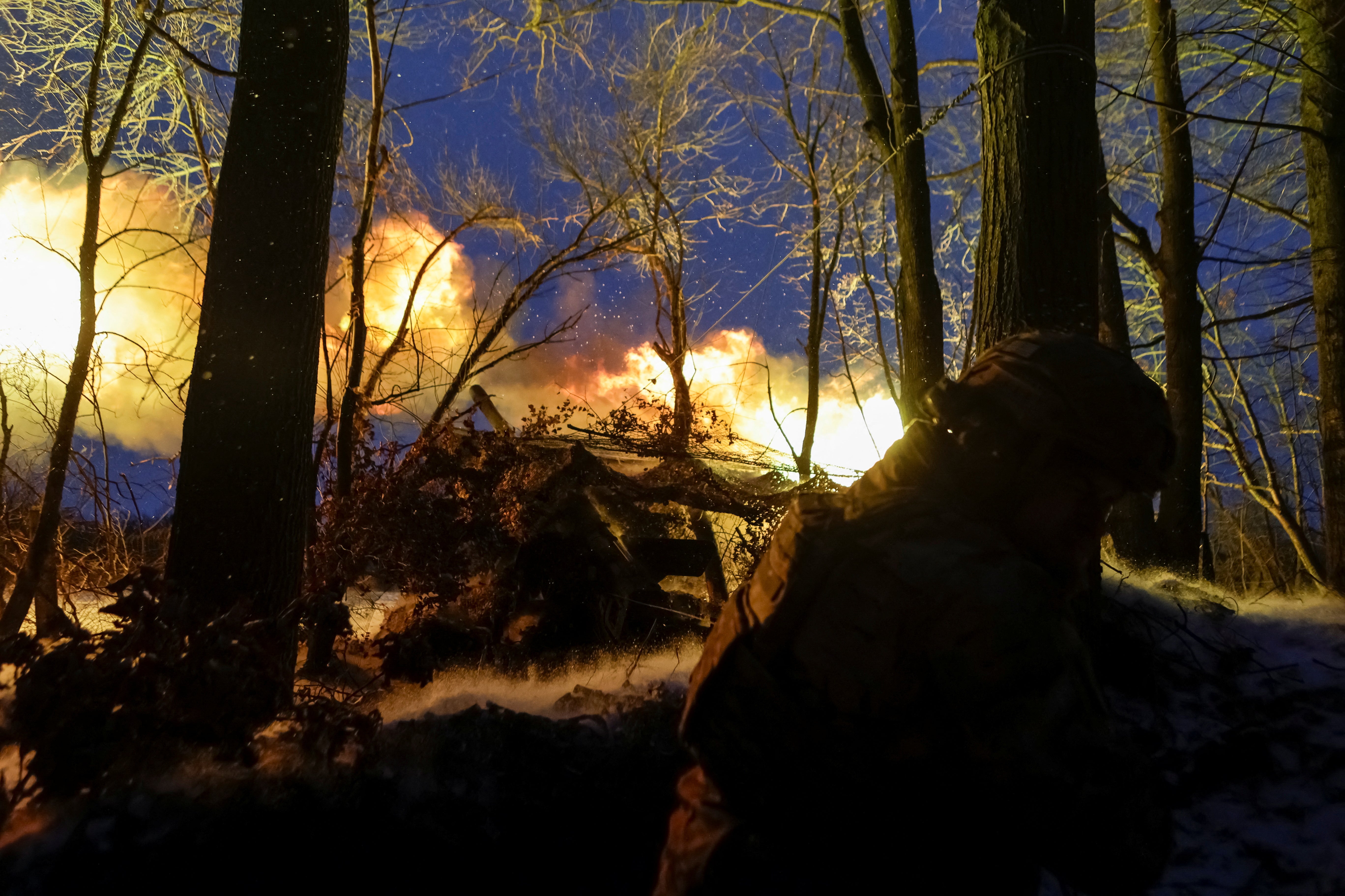 Ukrainian soldiers fire towards Russian positions in northeastern Ukraine