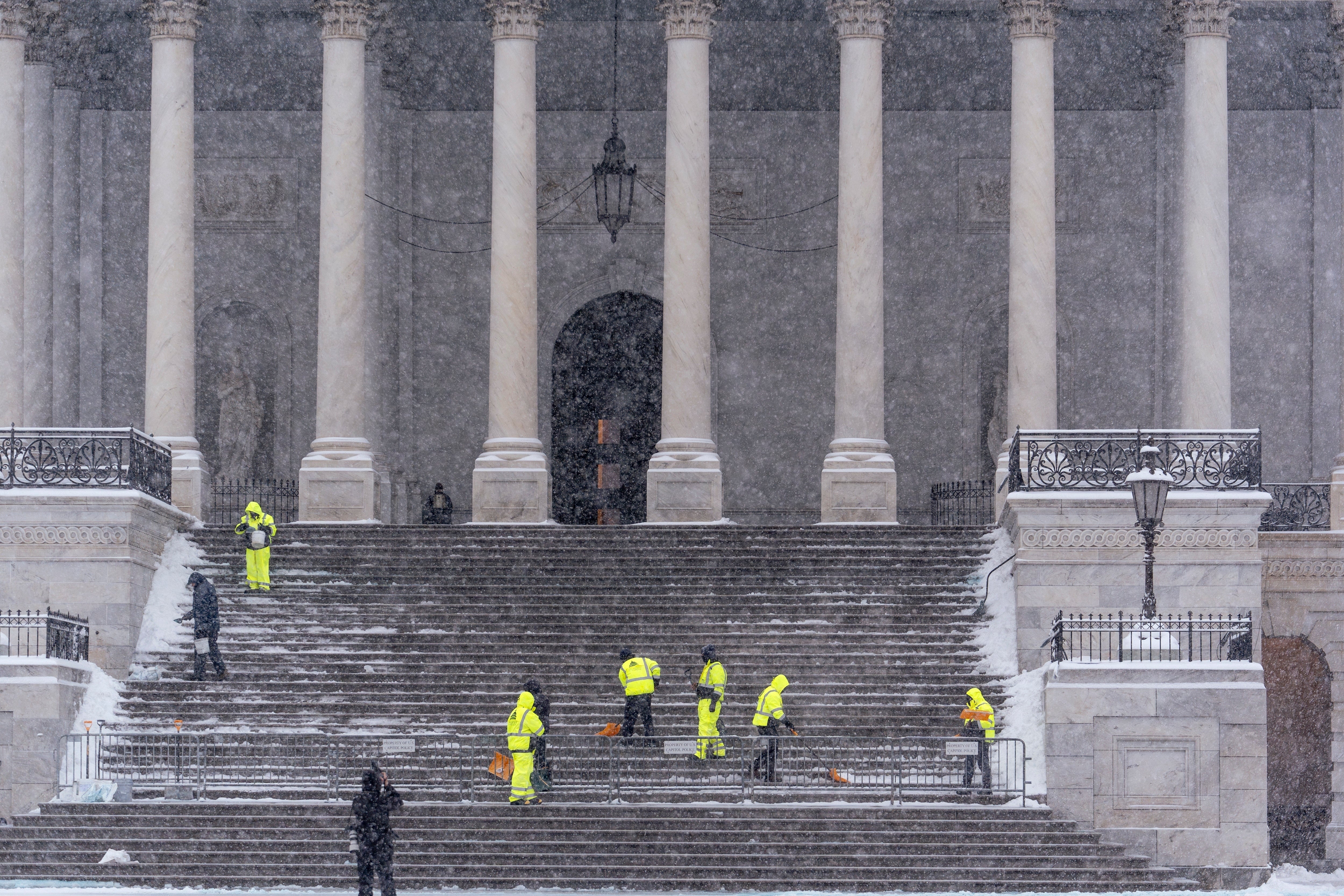 Workers clear steps at the Capitol in Washington, Monday, Jan. 6, 2025