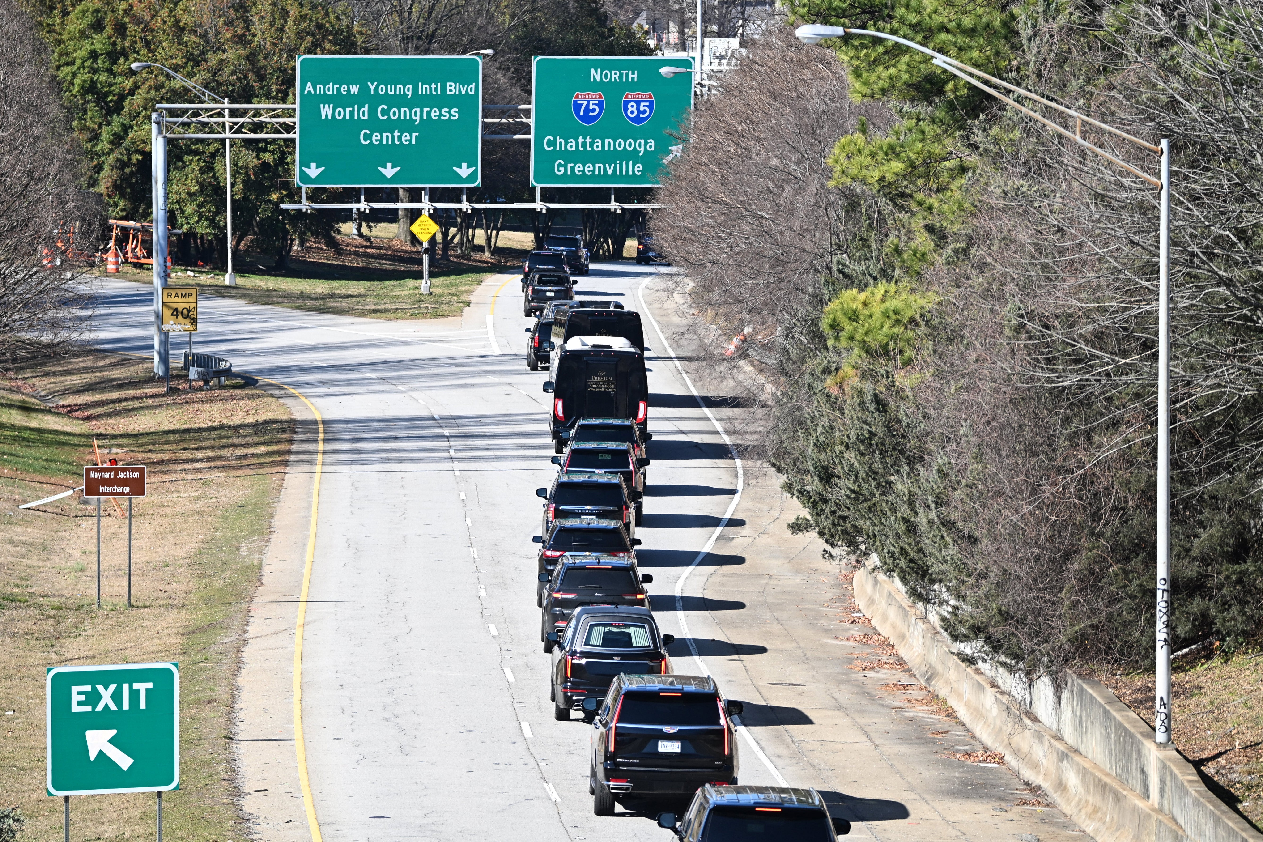 The motorcade with the hearse carrying the casket of former US President Jimmy Carter drives through Atlanta, Georgia on its way to Dobbins Air Reserve Base on January 7, 2025