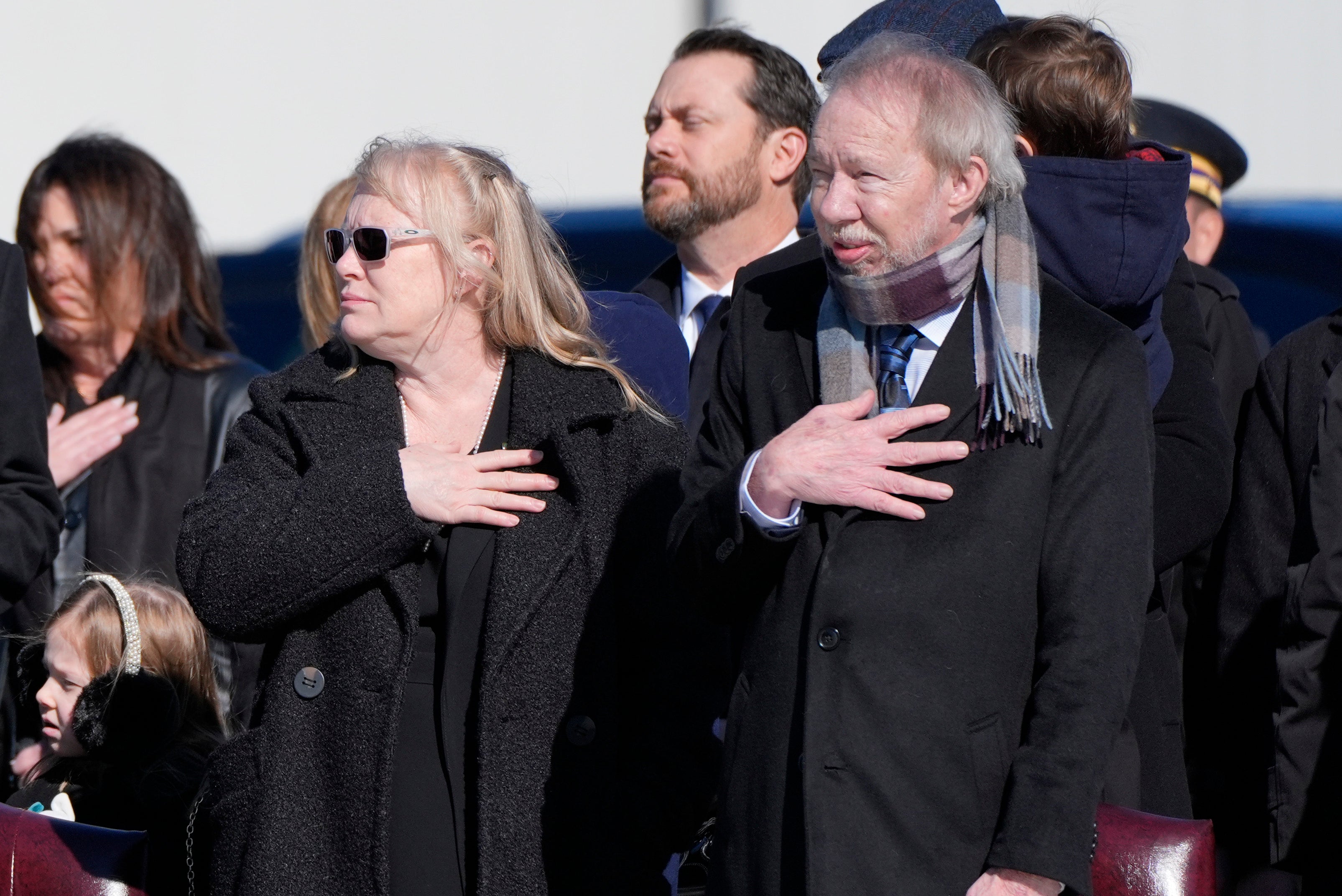 Amy Carter and Jeff Carter watch as the flag-draped casket of former U.S. President Jimmy Carter is placed on Special Air Mission 39 at Dobbins Air Reserve Base on January 7, 2025 in Marietta, Georgia