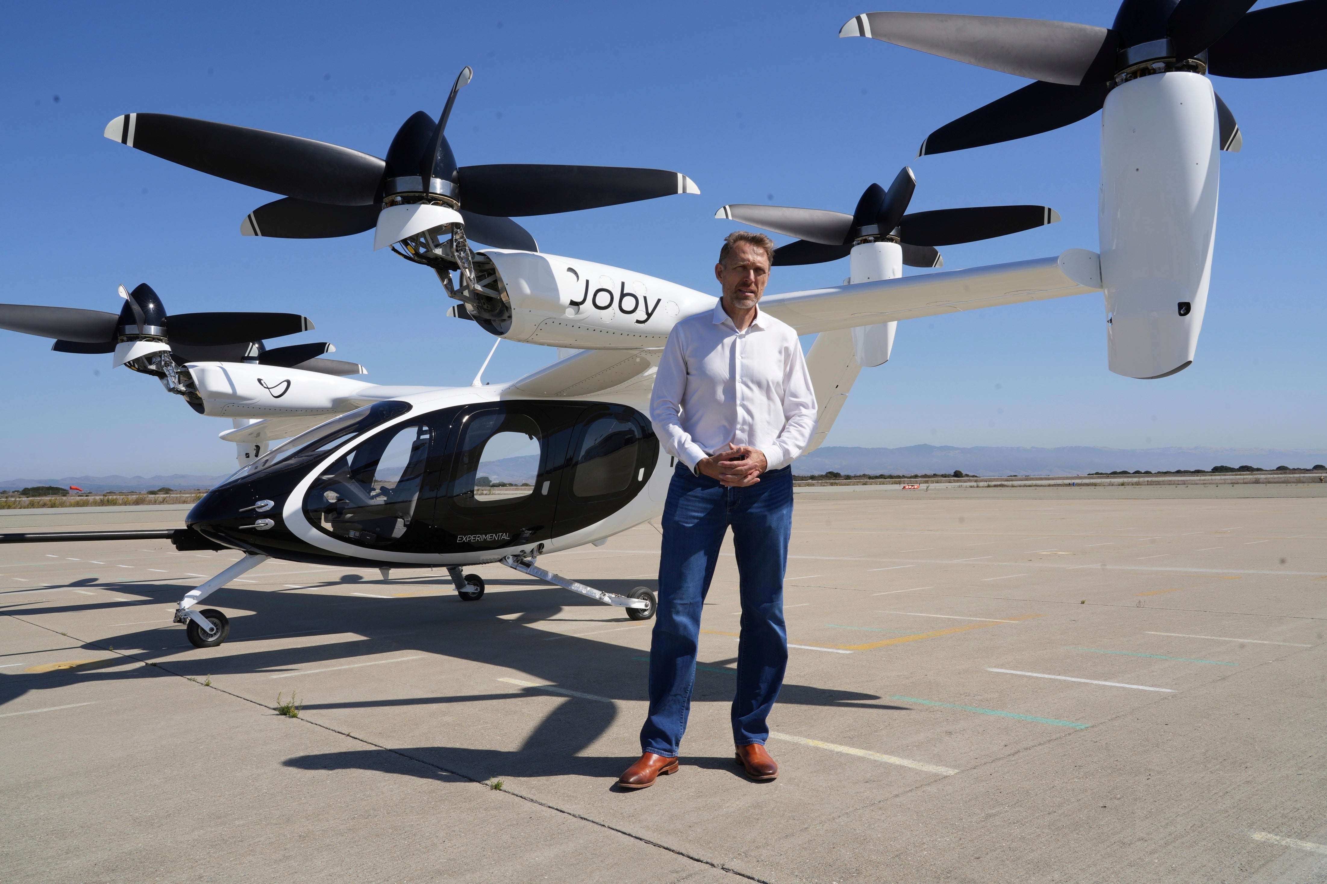 JoeBen Bevirt, CEO of Joby Aviation, stands next to an ‘electric vertical take-off and landing’ aircraft, also known as an eVTOL, in Marina, Cali