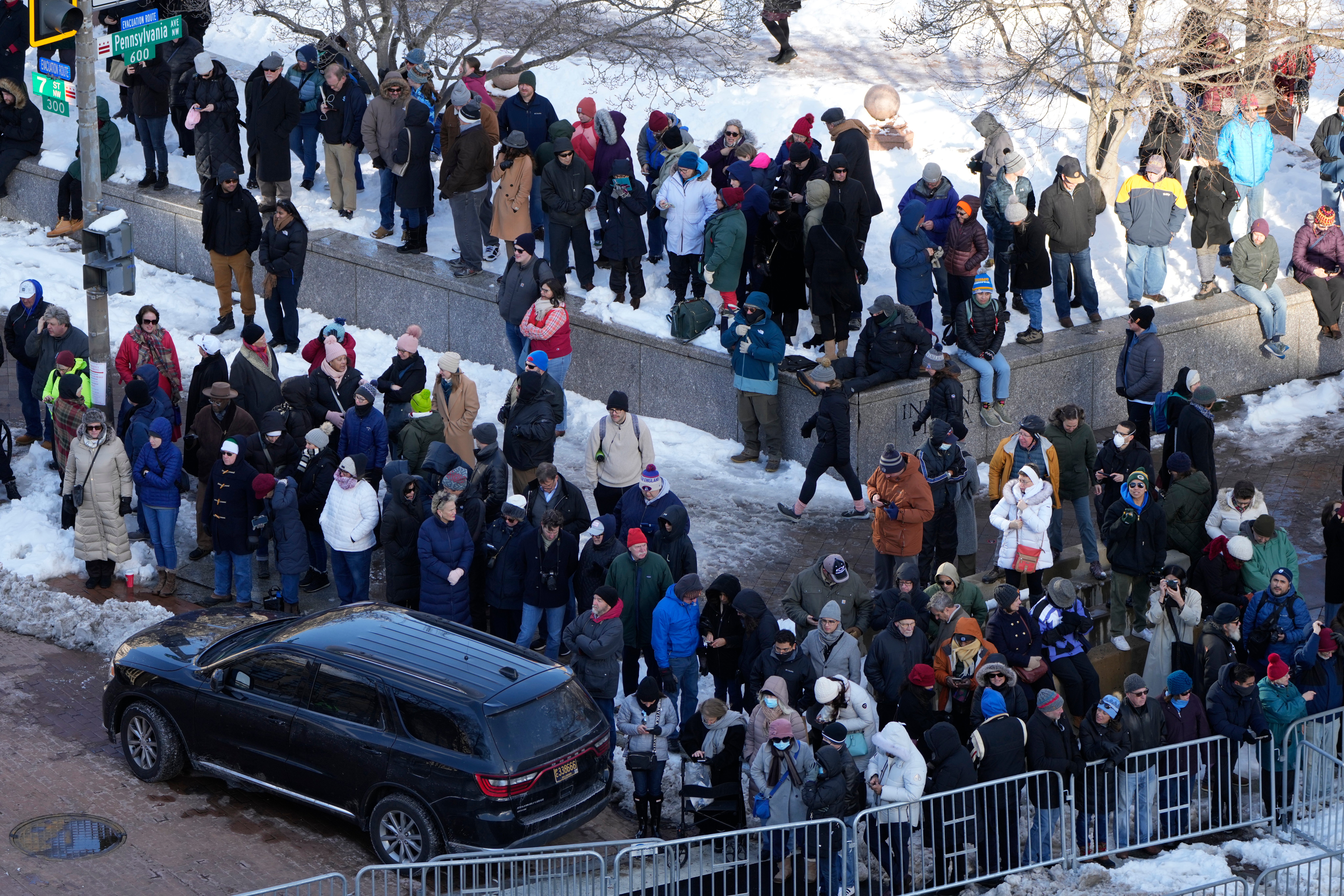 Spectators wait for the casket of former President Jimmy Carter to arrive at the U.S. Navy Memorial before traveling on to the Capitol on January 7, 2025 in Washington, DC