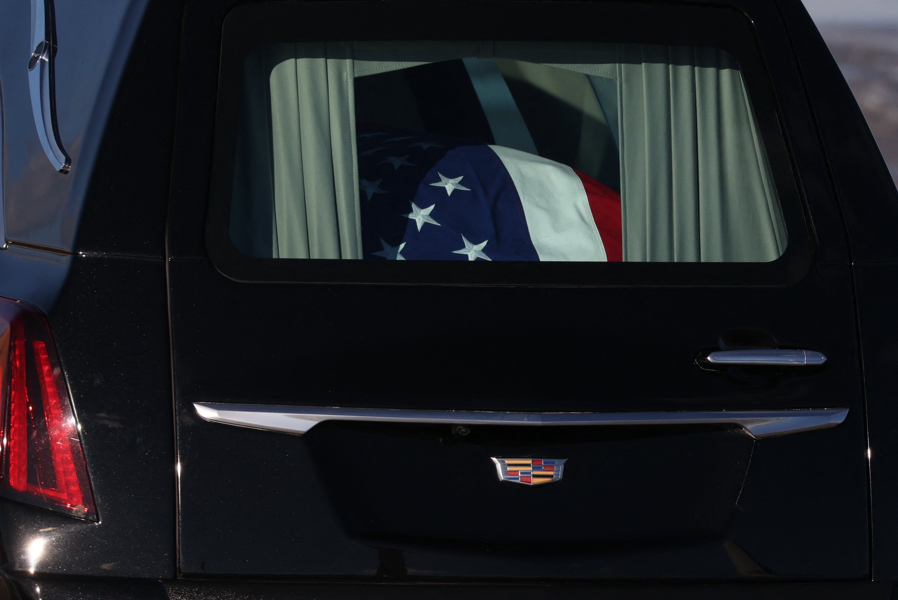 The flag-draped casket of former US President Jimmy Carter is tranfered to a hearse during an arrival ceremony in Joint Base Andrews, Maryland, on January 7, 2025