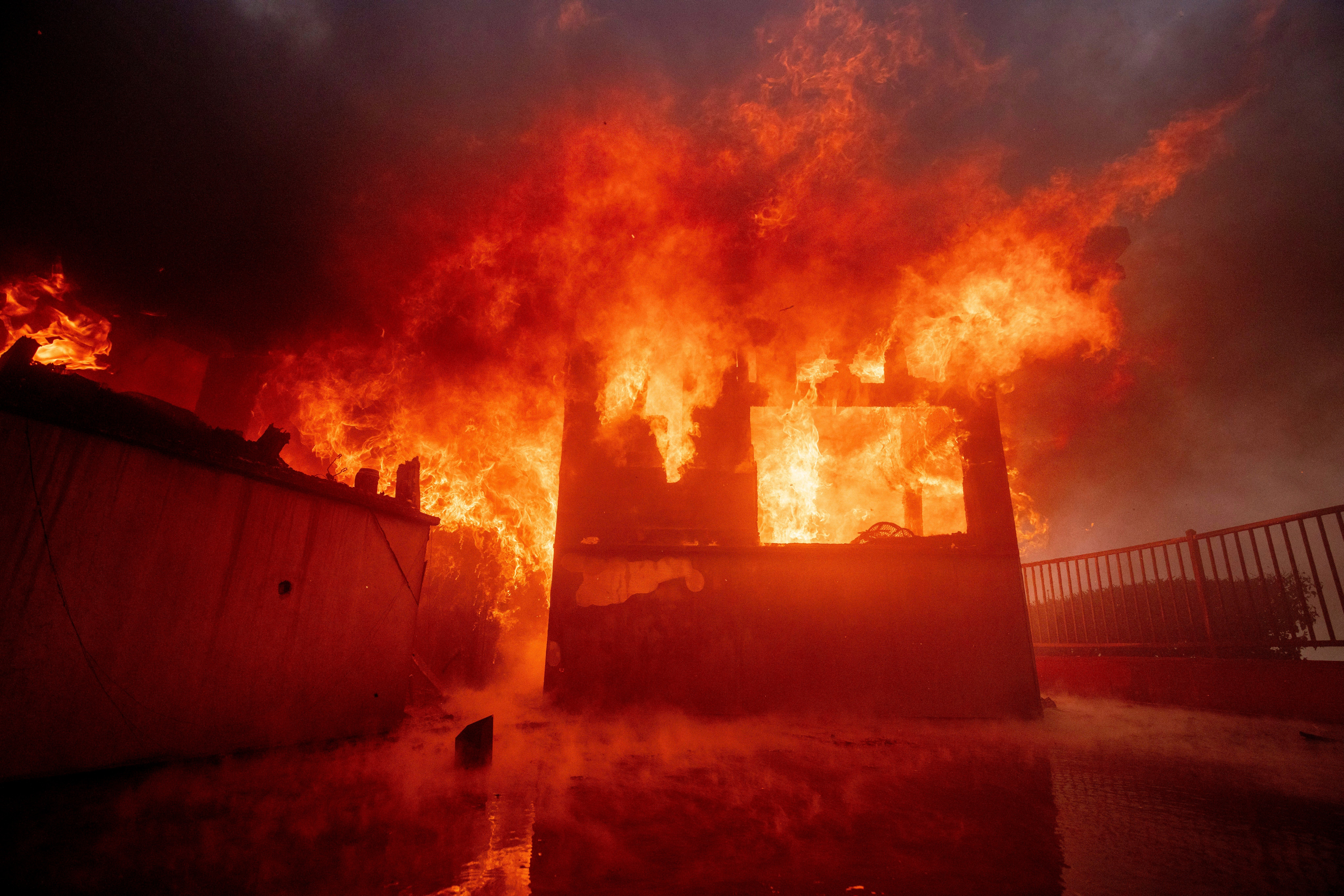 The Palisades Fire burns a property in the Pacific Palisades neighborhood of Los Angeles. It is one of several fires burning in the Los Angeles area that have damaged at least 1,000 buildings