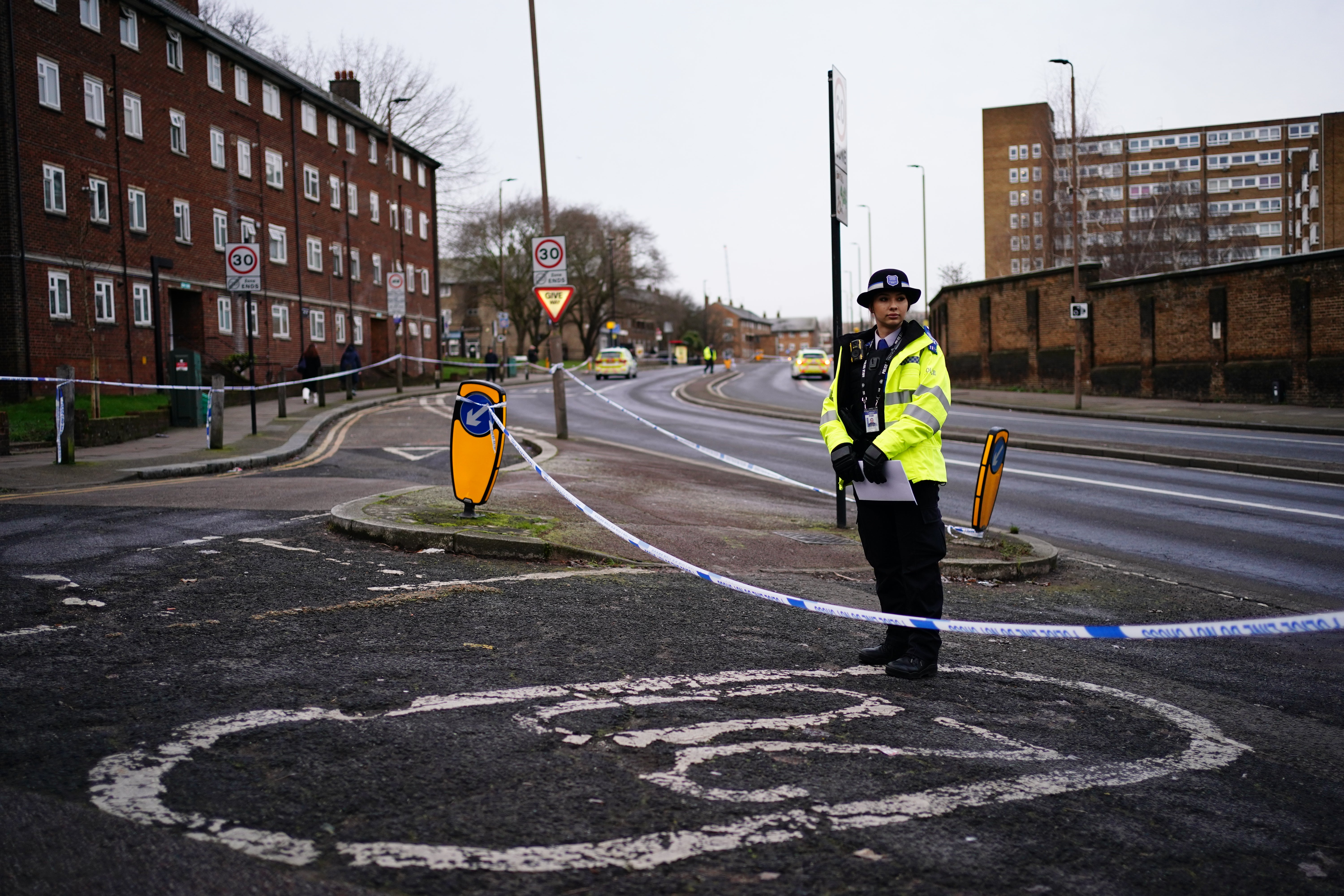 A police officer on Woolwich Church Road, which was cordoned off as part of the investigation