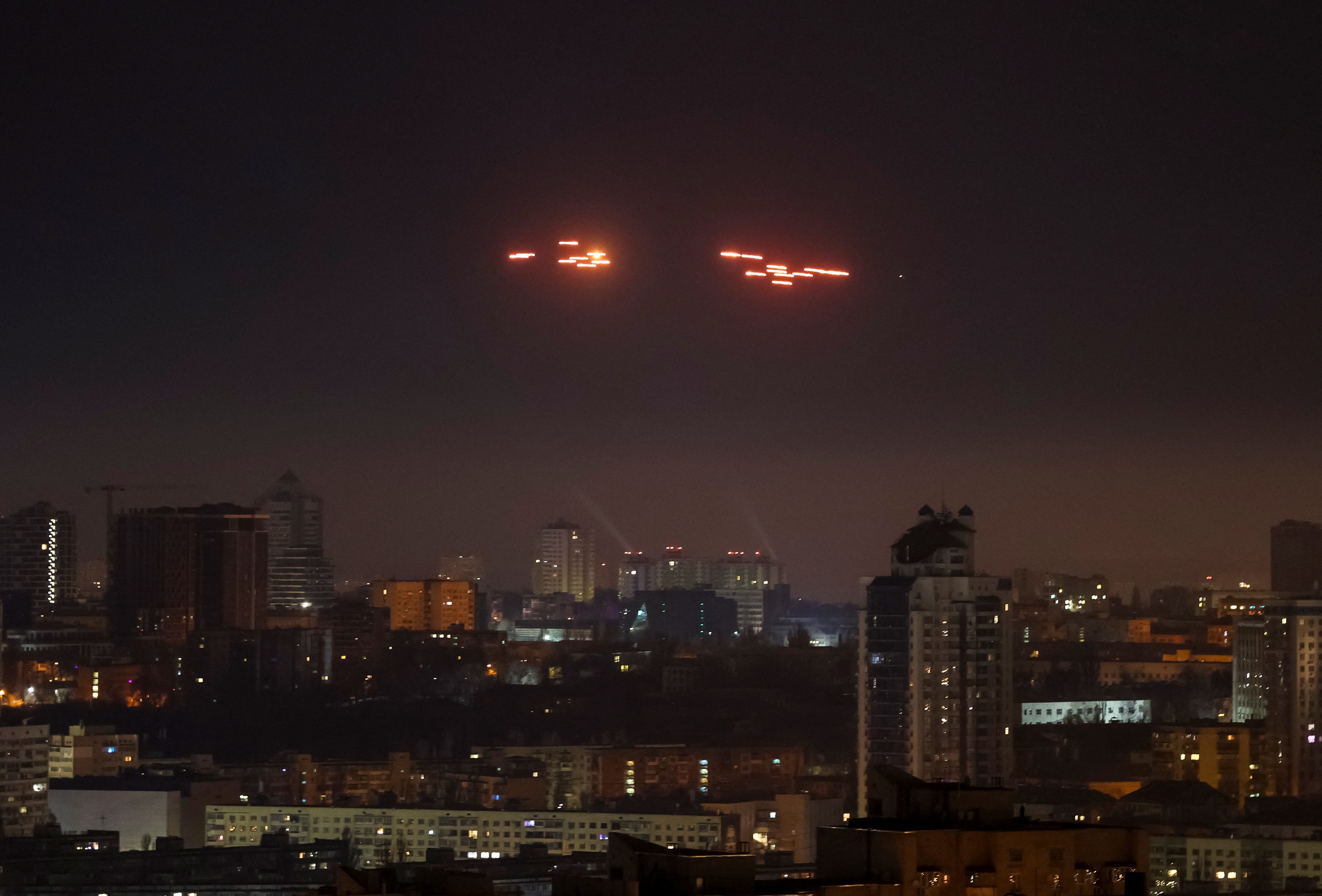 Tracers are seen in the night sky as Ukrainian servicemen fire at the drone during a Russian drone strike in Kyiv, Ukraine