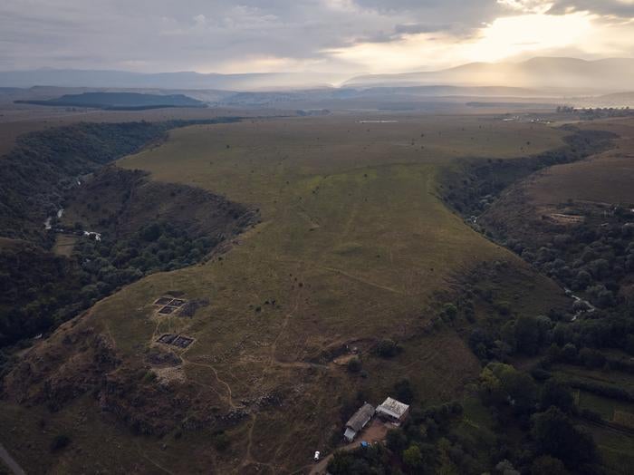 Atmospheric photo of the site at dusk showing the location at the convergence of two gorges