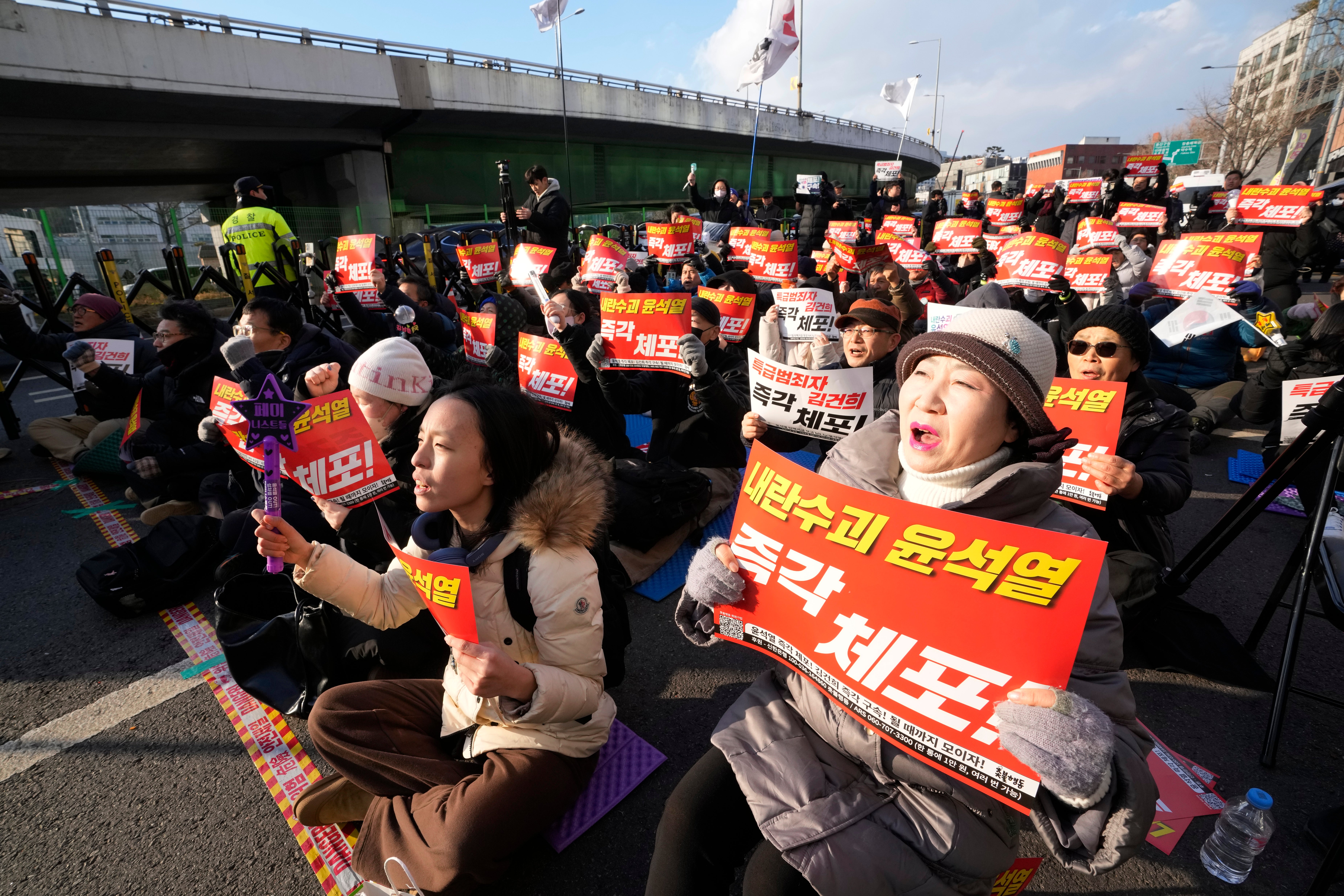 Protesters attend a rally demanding the arrest of impeached South Korean President Yoon Suk Yeol near the presidential residence in Seoul, South Korea