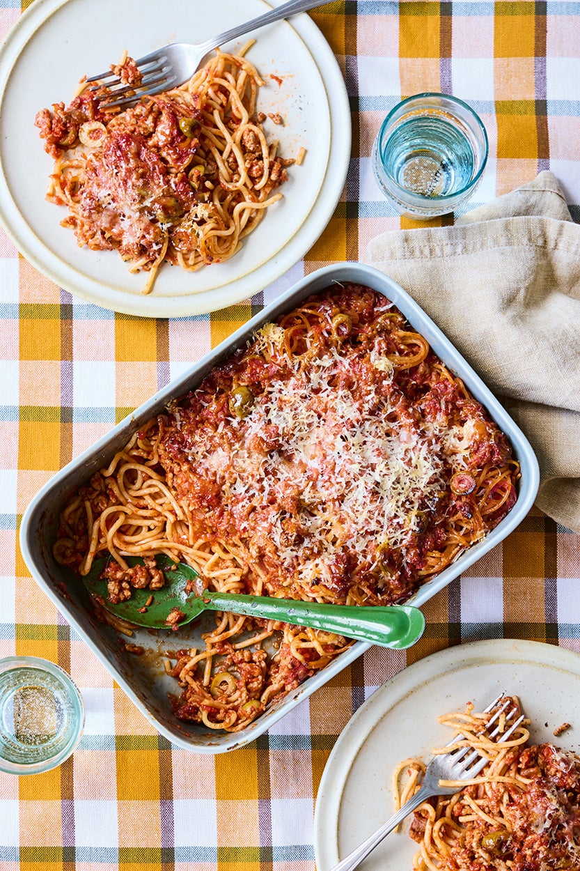 This baked spaghetti swaps indulgence for balance with lean pork and savoury olives