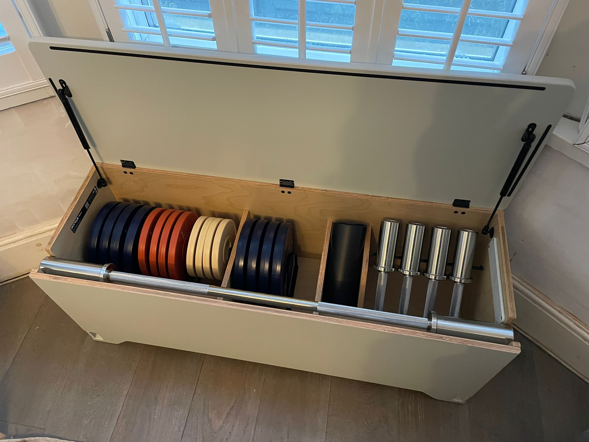 Everything has its place in the Fittle Box, including two adjustable dumbbells and one adjustable barbell