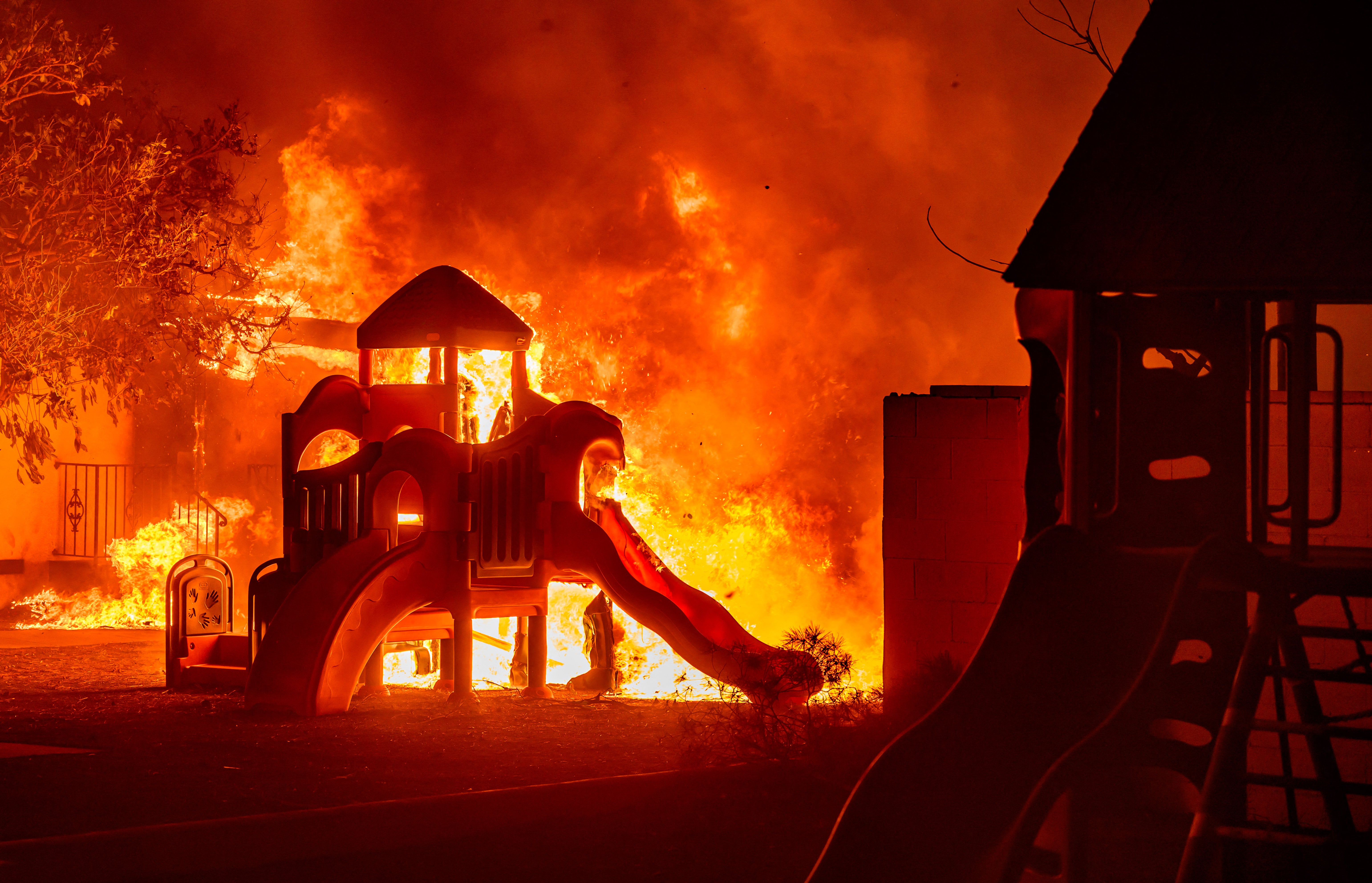 A playground burns in a residential neighborhood during the Eaton fire in Pasadena