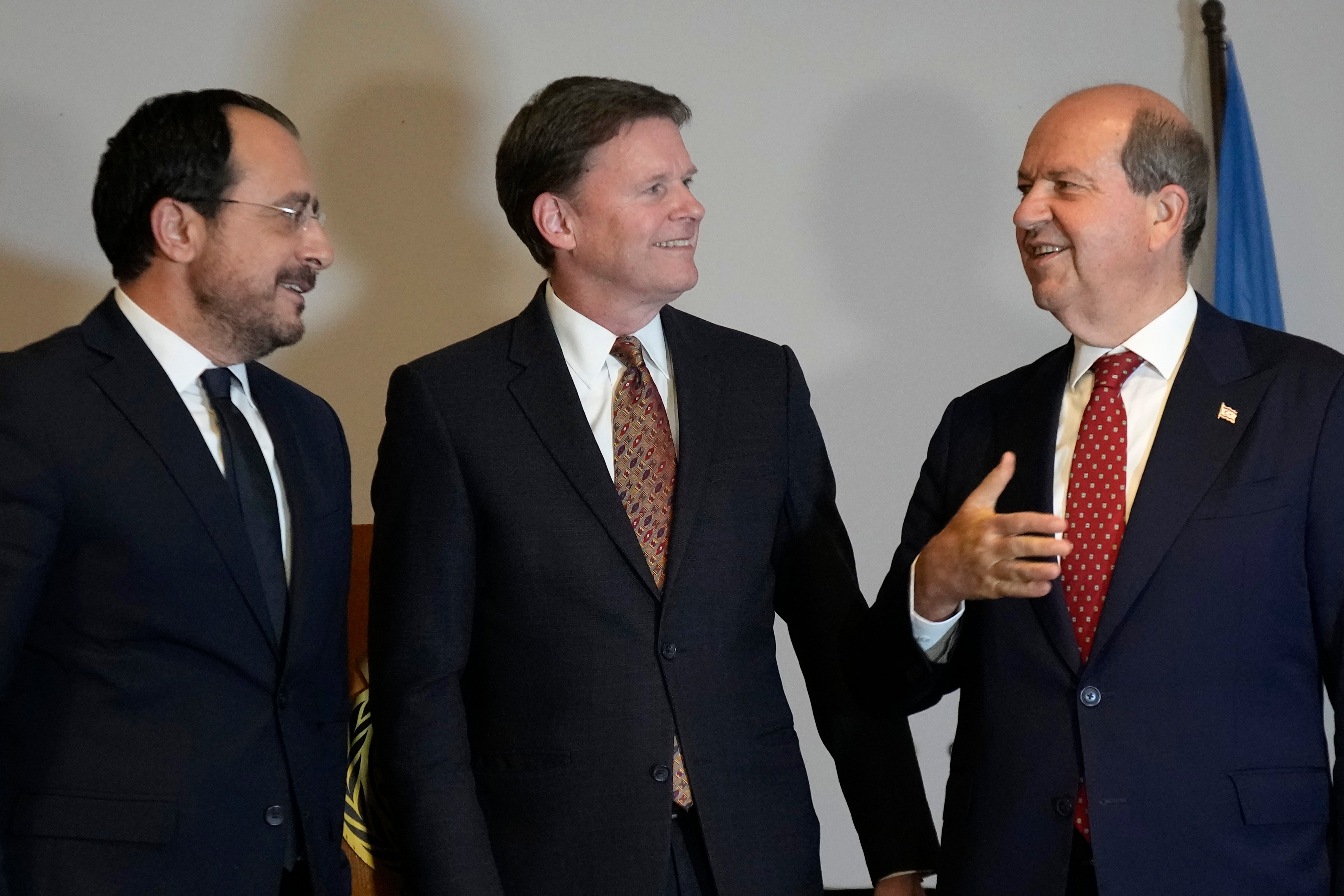 U.N. Secretary General's Special Representative in Cyprus Colin Stewart, center, Cyprus' President Nikos Christodoulides, left, and the Turkish Cypriot leader Ersin Tatar talk as they attend the U.N.'s end of year reception at Ledras Palace inside the U.N buffer zone in the divided capital Nicosia, Cyprus, Tuesday, Dec. 10, 2024. (AP Photo/Petros Karadjias)