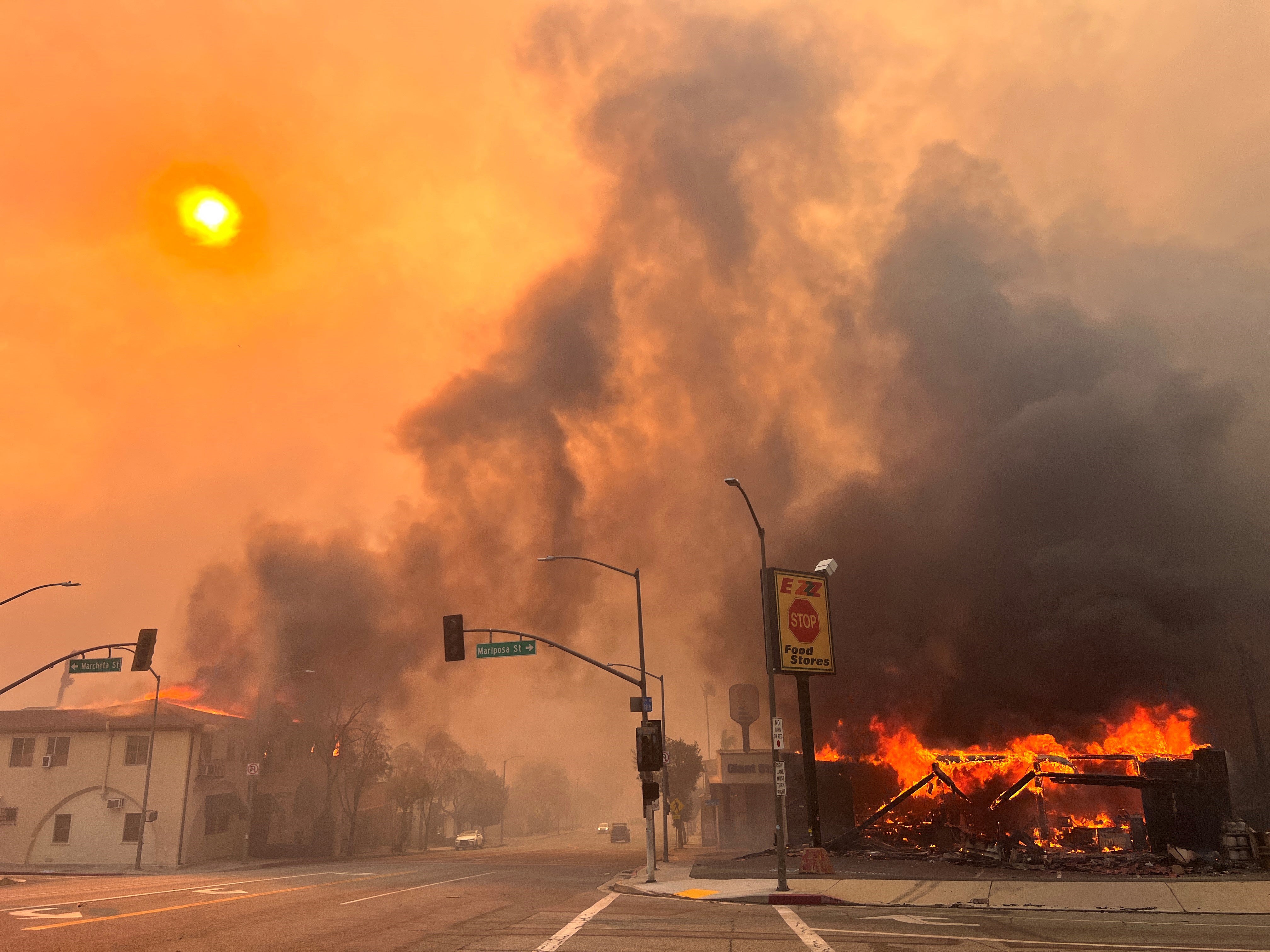 Flames from the wind-driven Eaton fire engulf a house in Altadena, California, on Wednesday. The fire now spans more than 10,000 acres