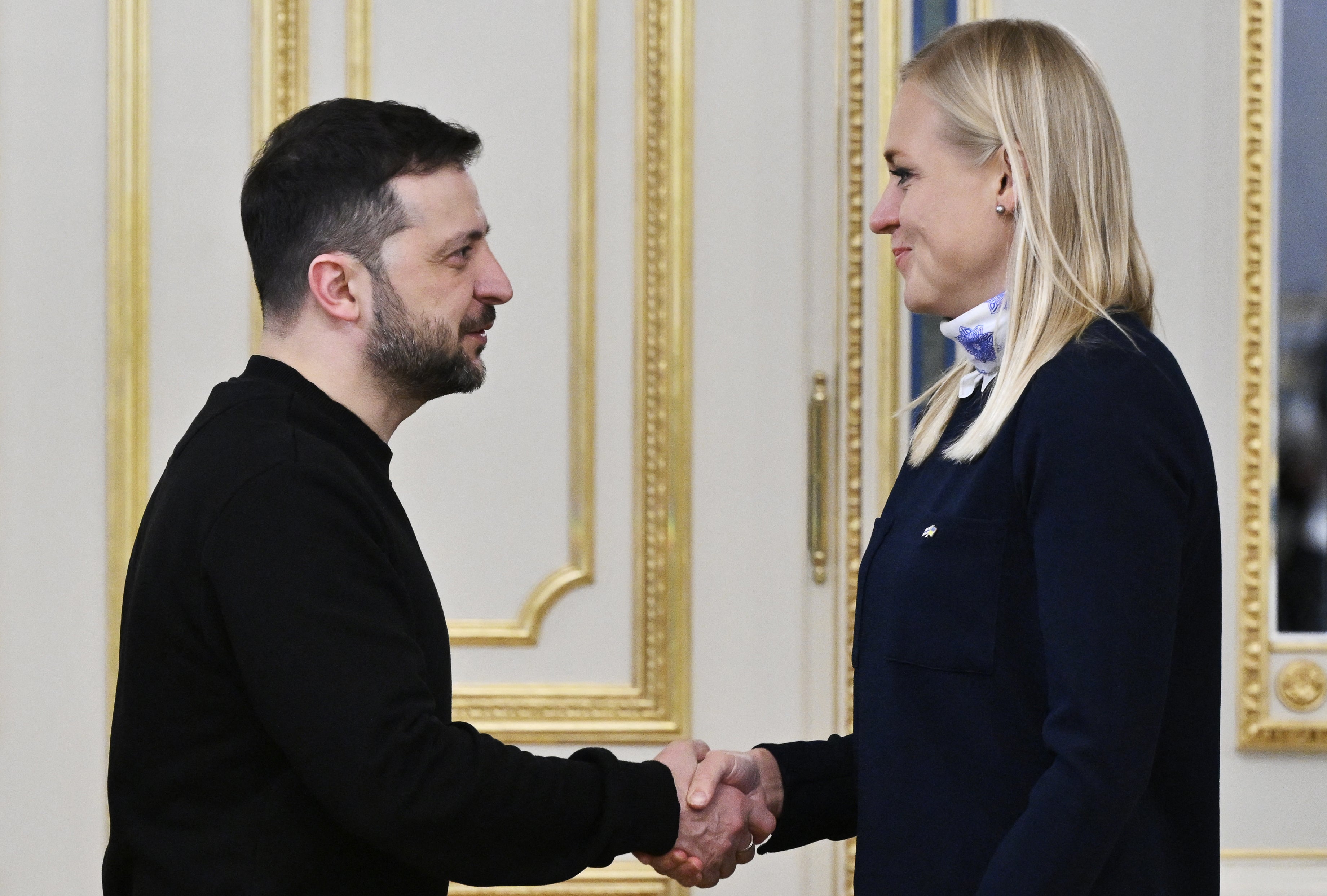 Volodymyr Zelensky shakes hands with Finland’s minister of foreign affairs Elina Valtonen during their meeting in Kyiv