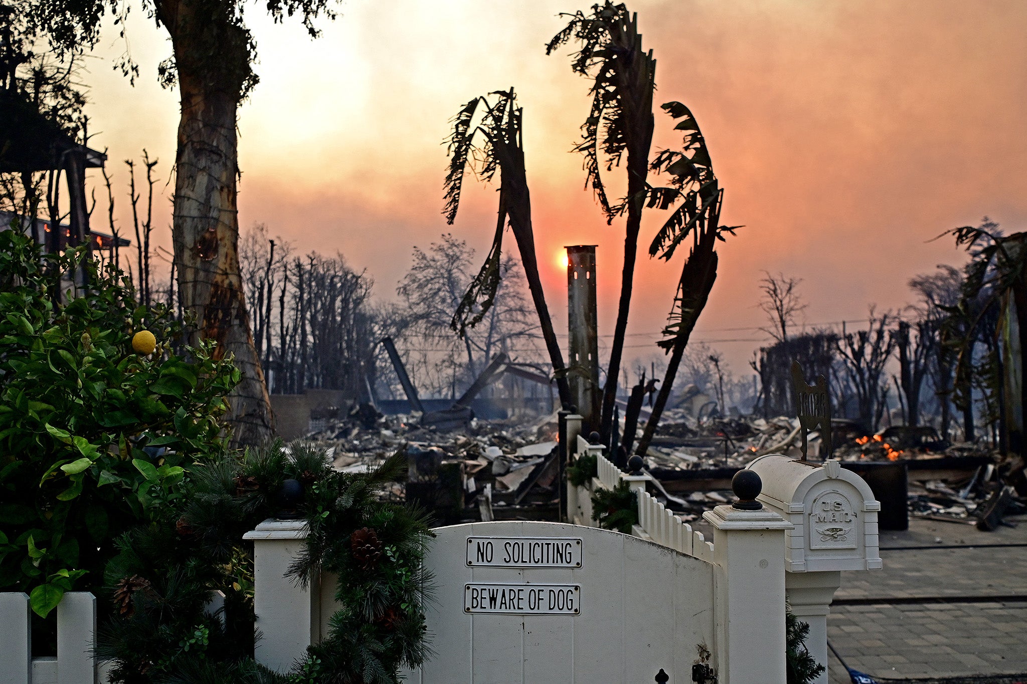 The front gate of a burning home after a wildfire spread across the Pacific Palisades in California