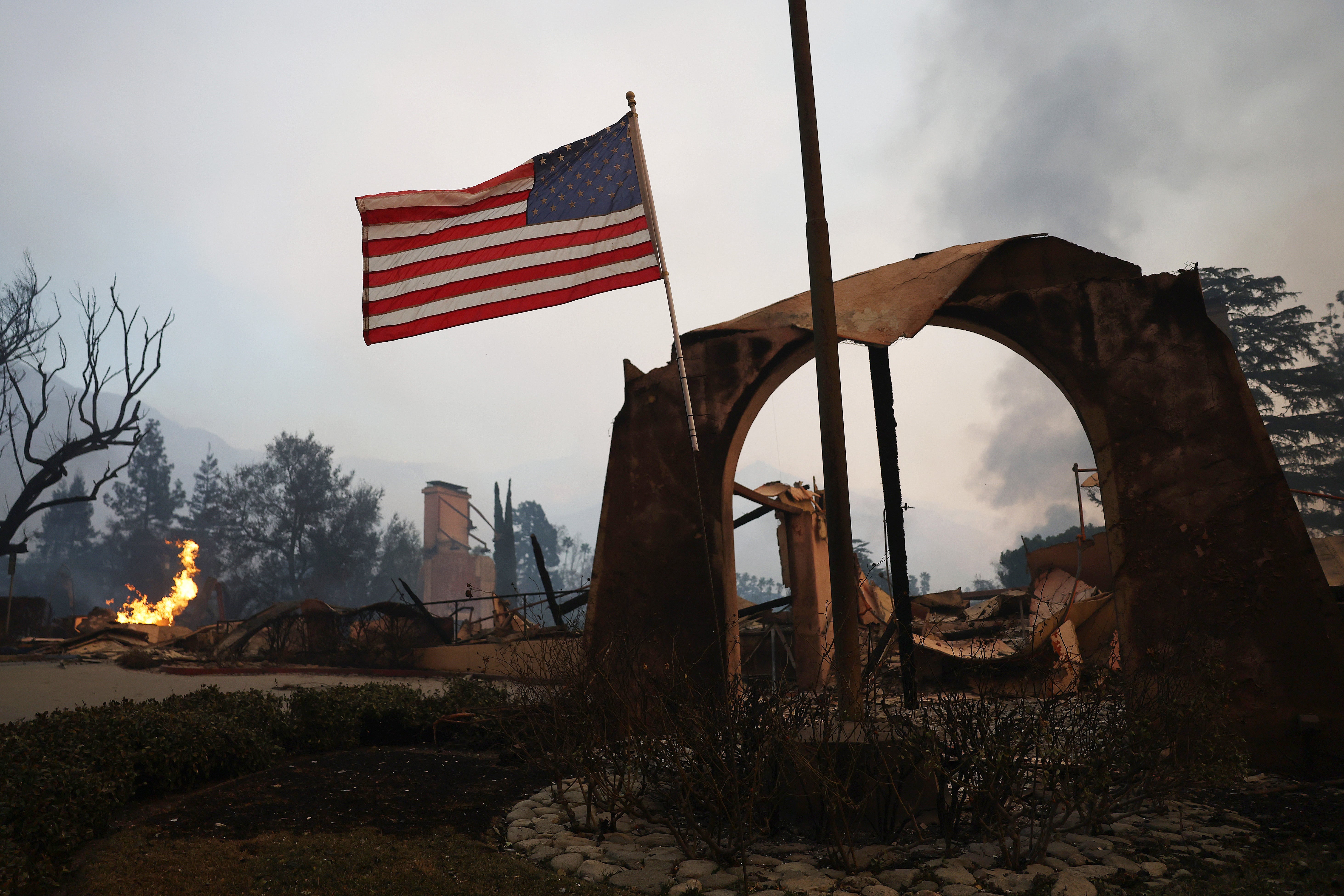 The American flag remains outside the entrance of the country club