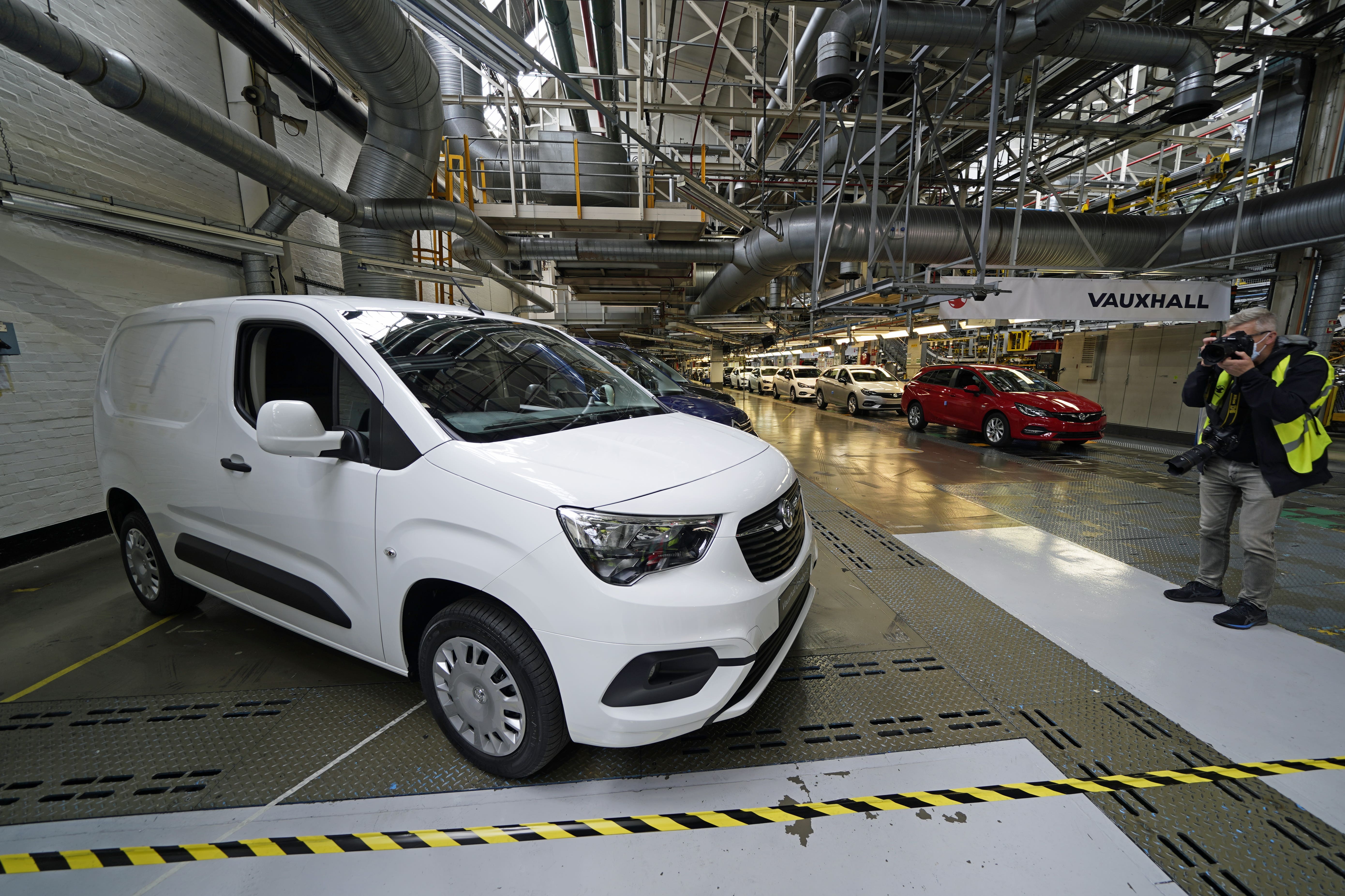 A photographer takes a picture of a new electric van at Vauxhall’s plant in Ellesmere Port, Cheshire (PA)