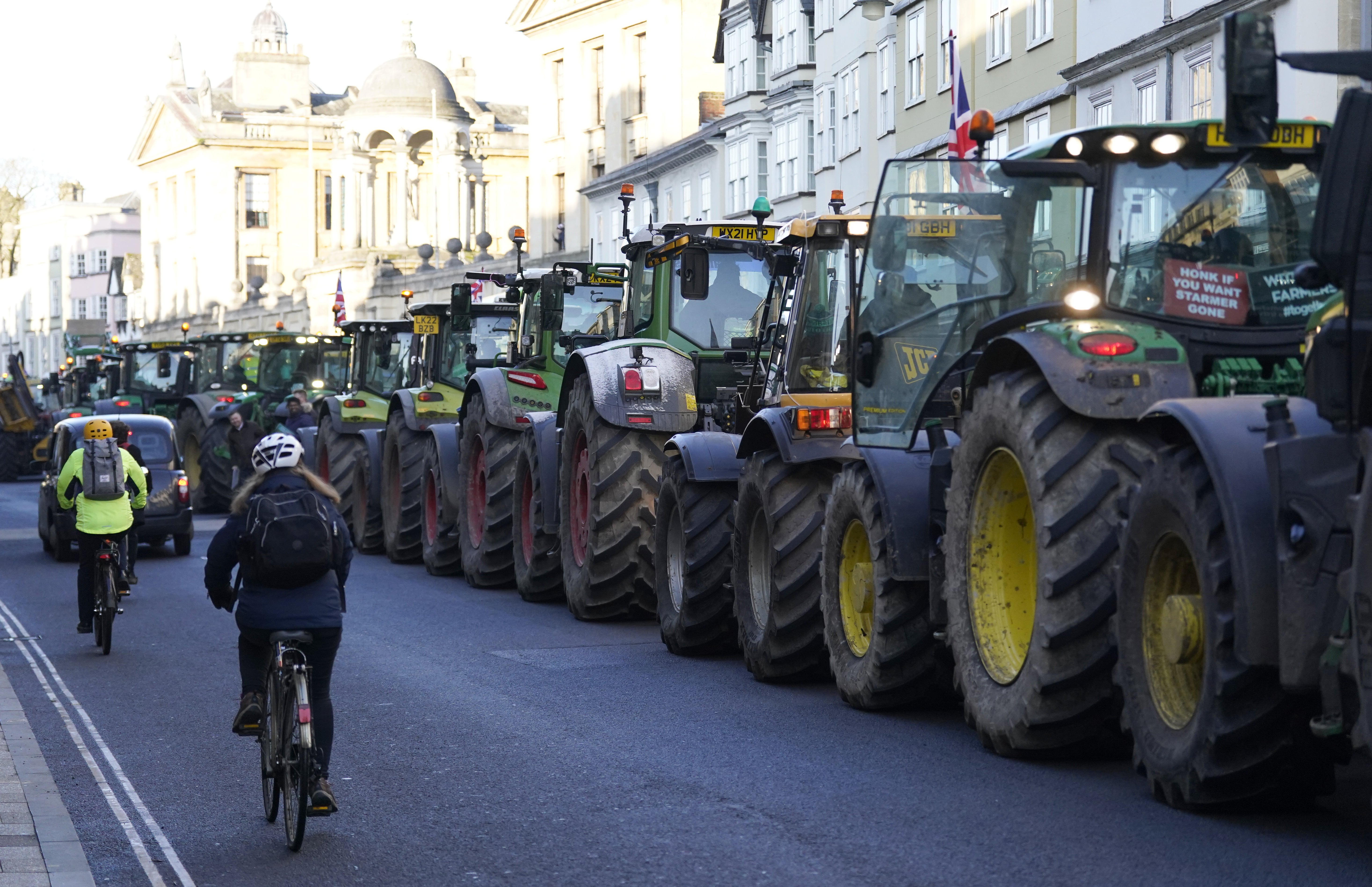 Tractors lined up as farmers take part in a protest over the changes to inheritance tax (IHT) rules outside the Oxford Farming Conference (Andrew Matthews/PA)