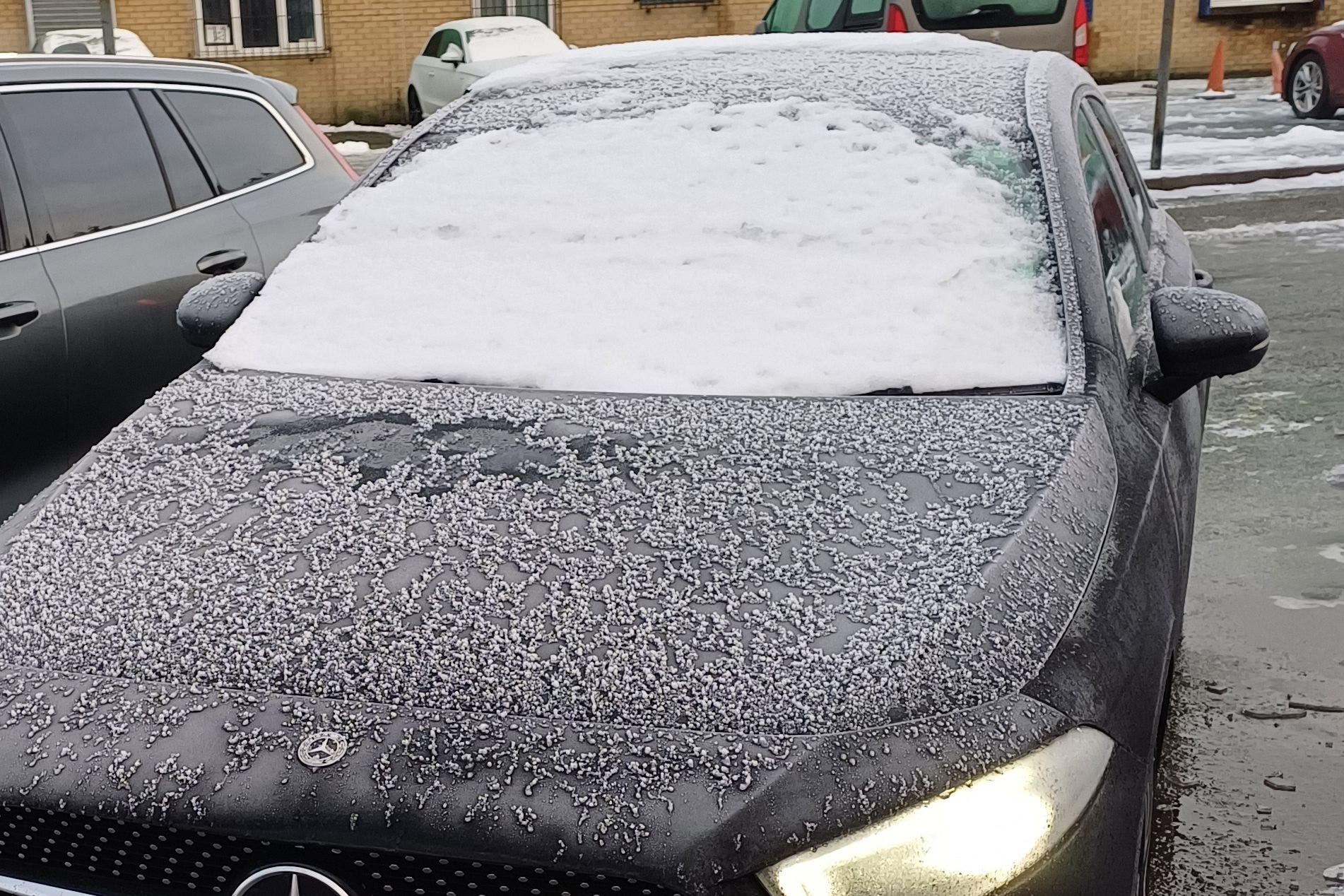 A motorist has been caught driving with their head out of the window ‘Ace Ventura-style’ because the car’s windscreen was covered in snow (Merseyside Police Roads Policing Unit/PA)