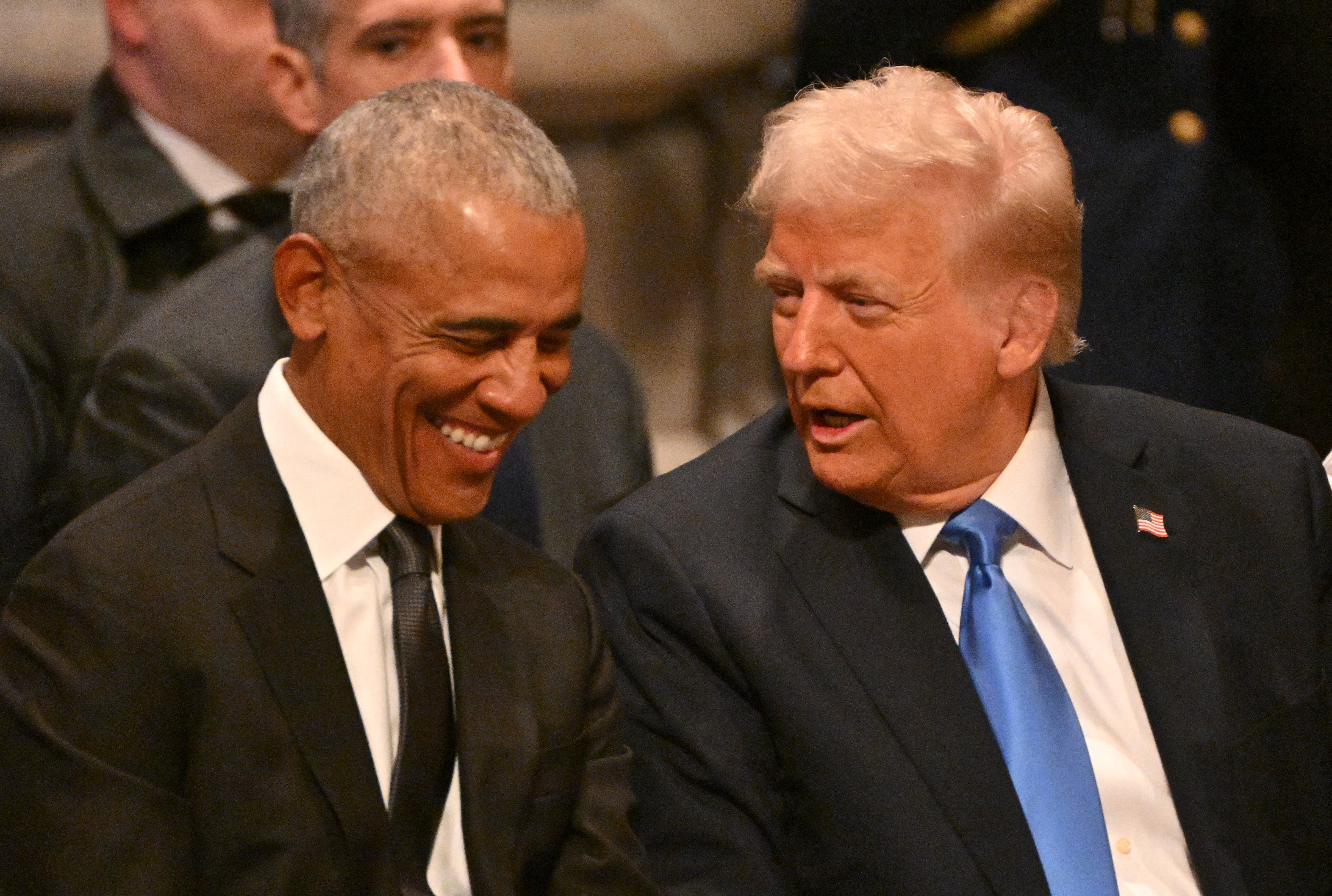 Obama and Trump share a laugh at Carter’s funeral on Thursday morning