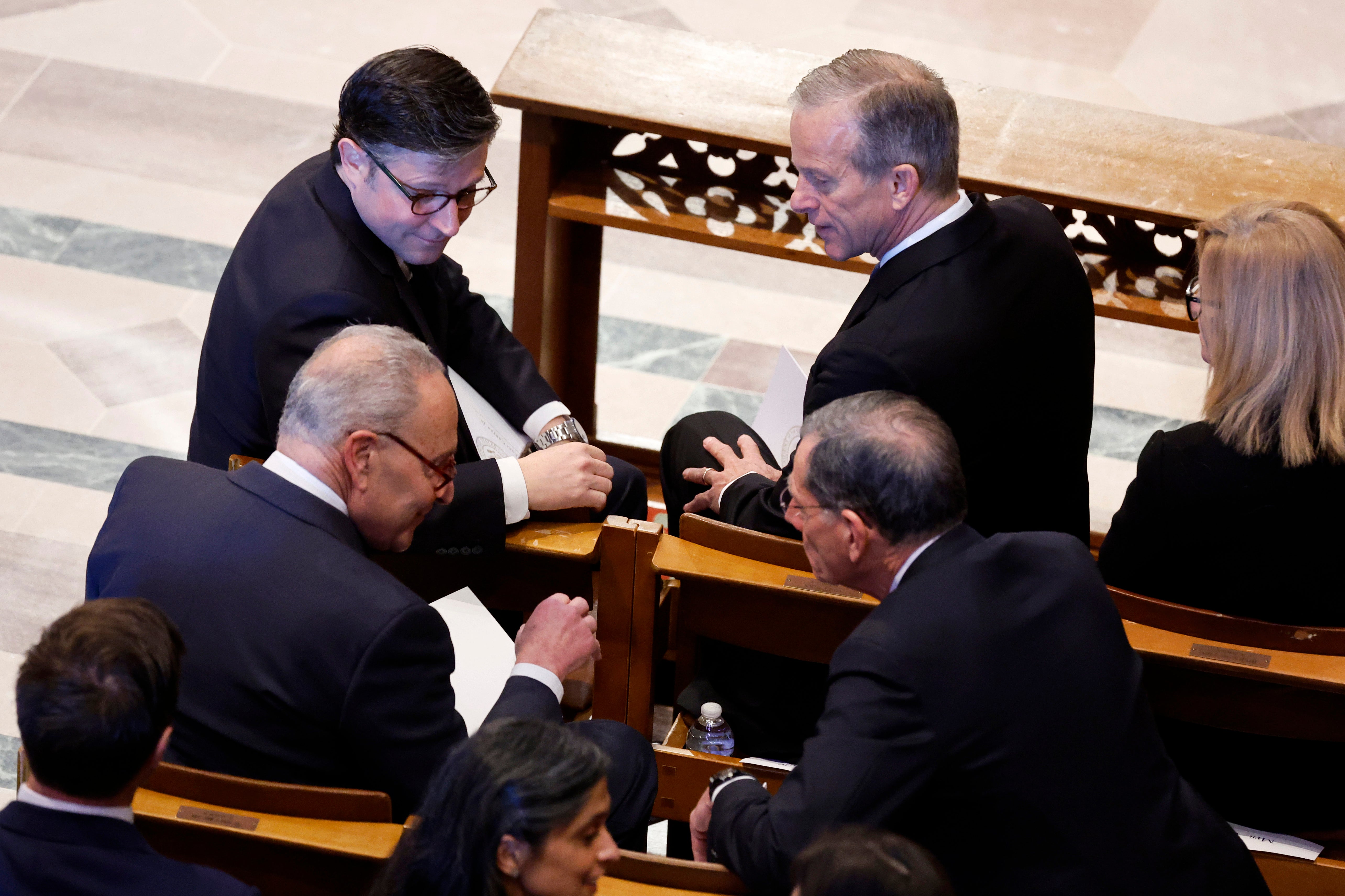 Speaker of the House Mike Johnson (R-LA), Senate Majority Leader John Thune (R-SD) Senate Minority Leader Charles Schumer (D-NY) and U.S. Sen. John Barrasso (R-WY) speak ahead of the state funeral for former U.S. President Jimmy Carter at Washington National Cathedral on January 09, 2025 in Washington, DC