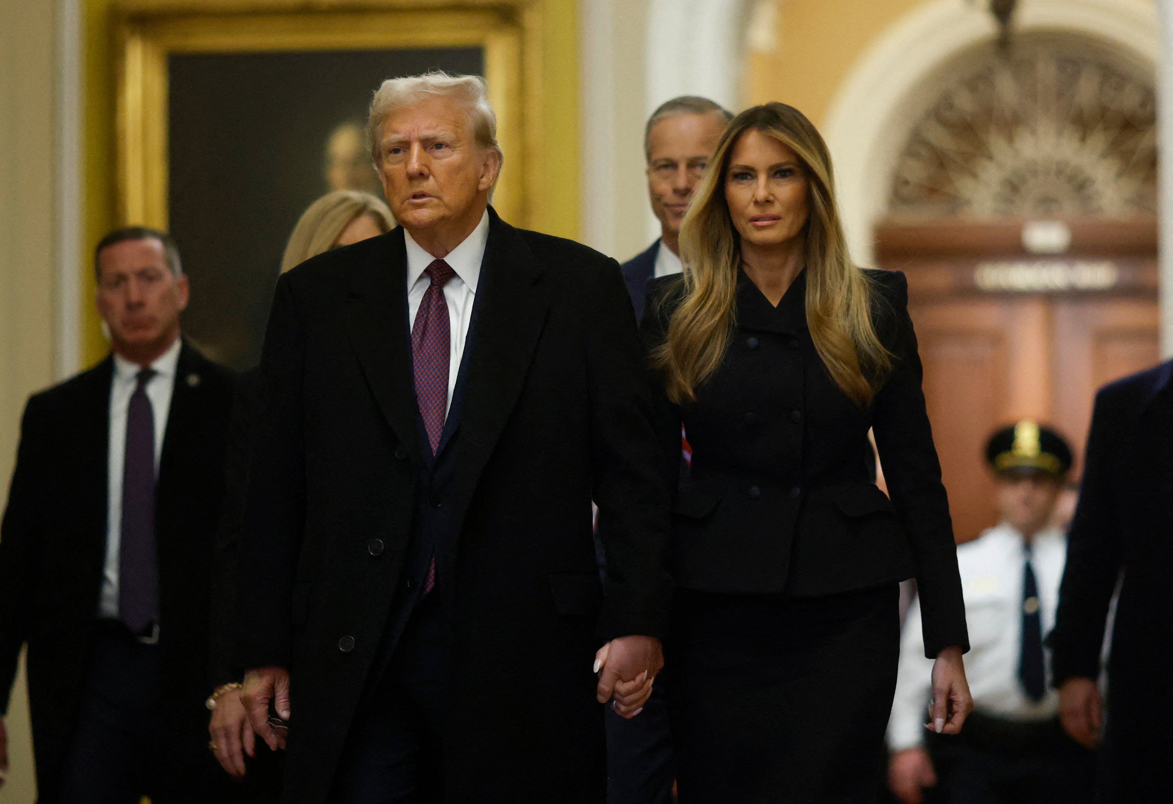 President-elect Donald Trump and former First Lady Melania Trump arrive to pay their respects to former president Jimmy Carter.