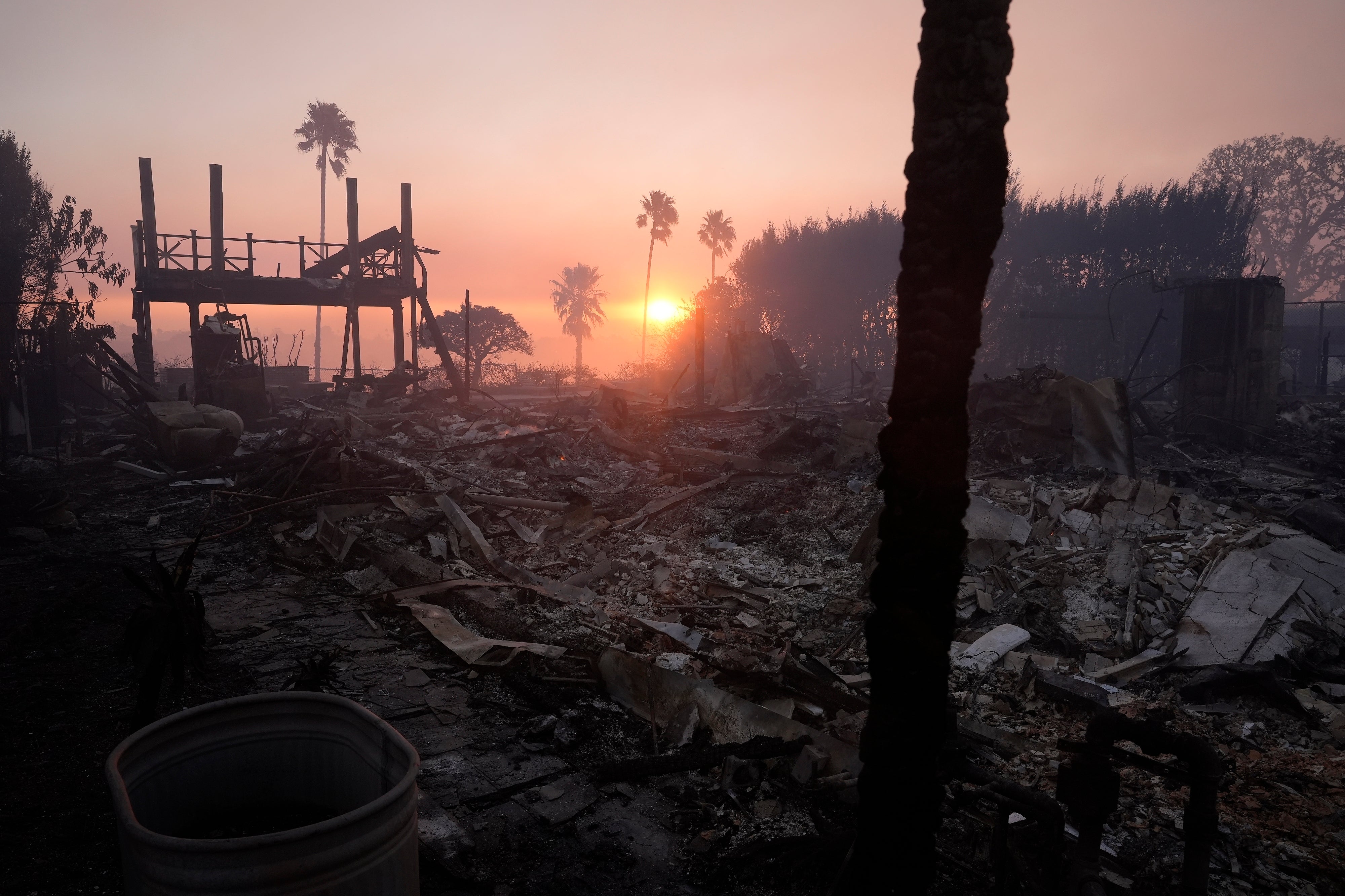 The sun rises after the Palisades Fire in the Pacific Palisades neighborhood of Los Angeles, California, on Thursday. Structures are burnt to the ground