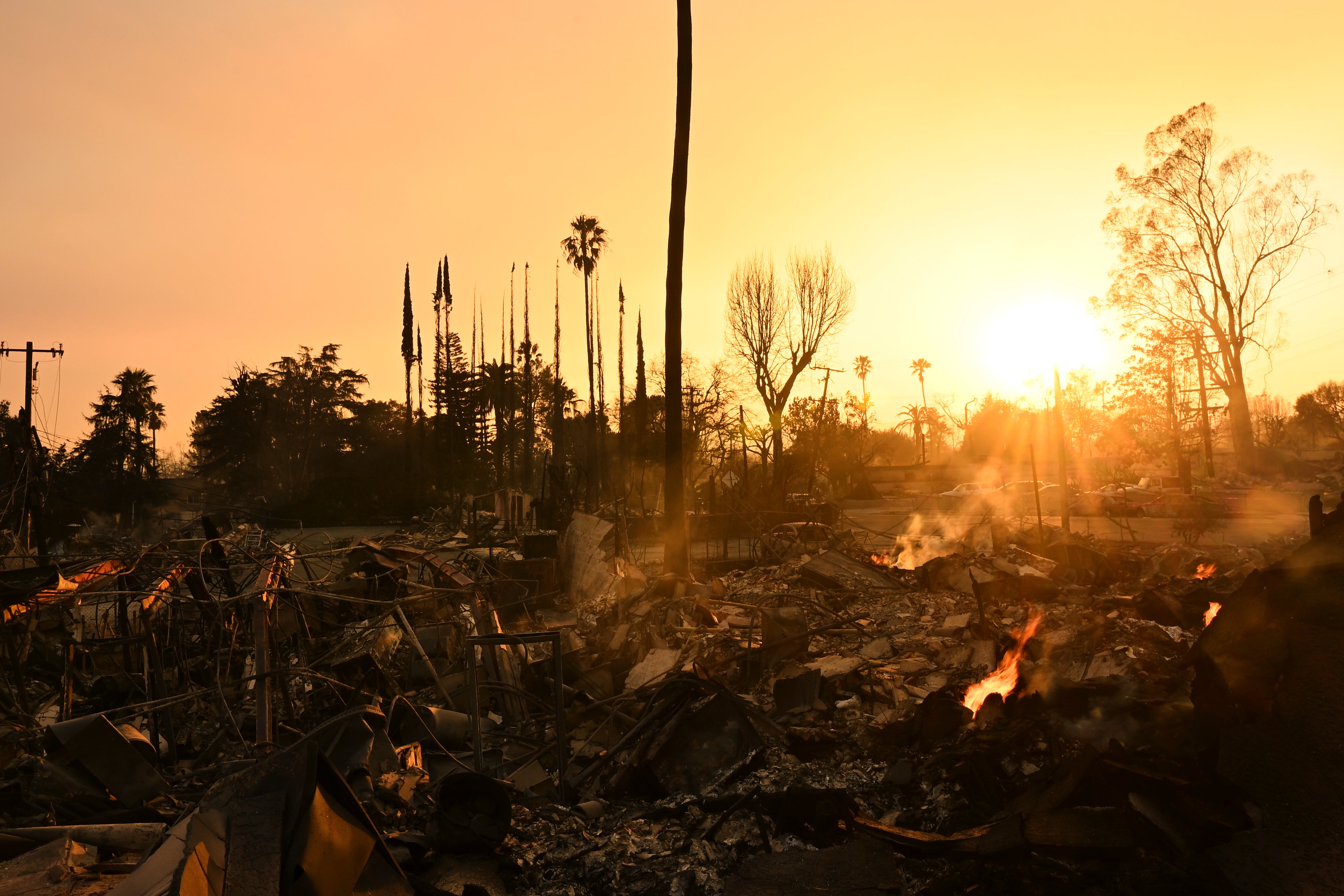 The sun sets over damage from the Eaton Fire,